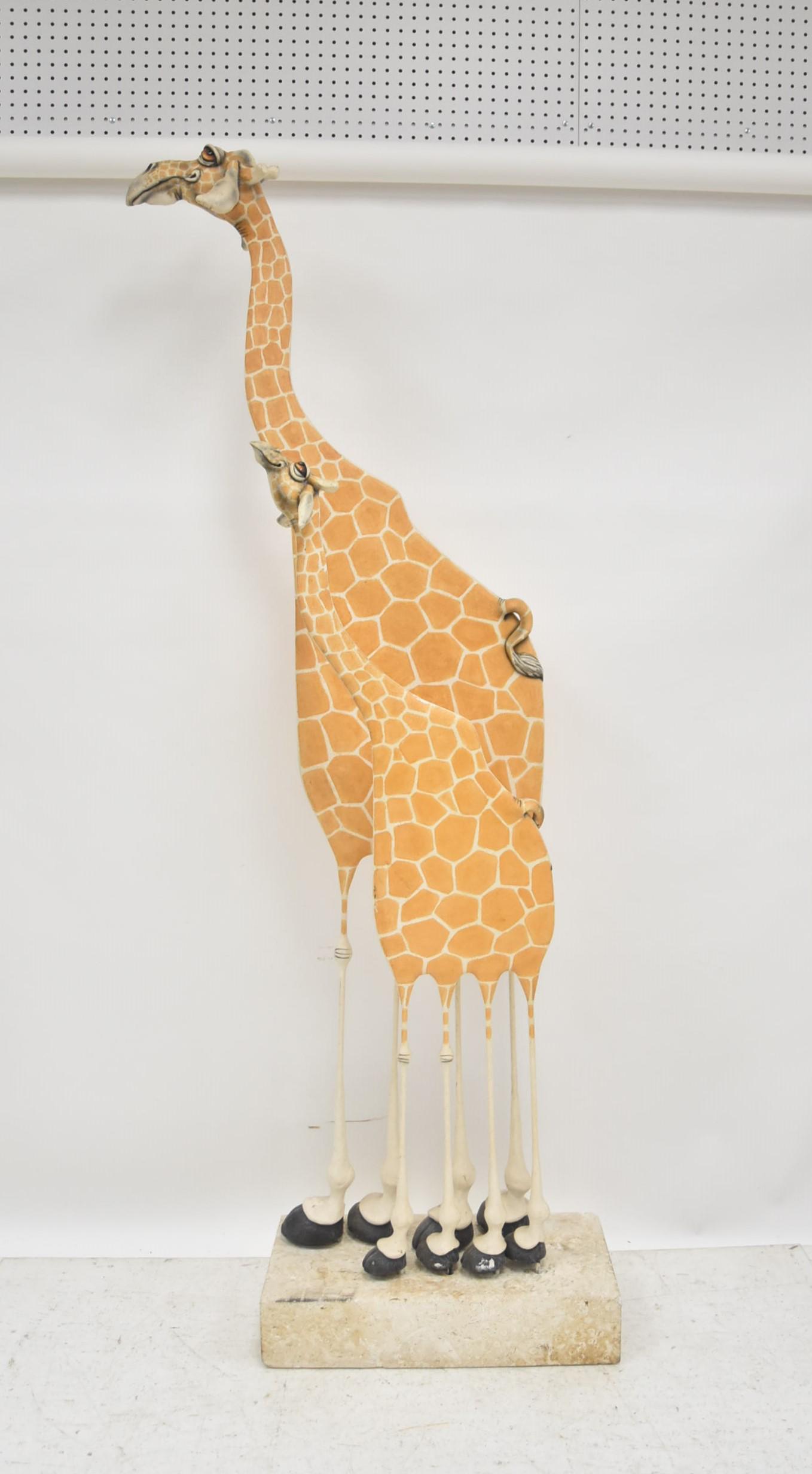 TODD WARNER GIRAFFE SCULPTURE: Todd J. Warner (American, b. 1945) Large Hand painted Wood, clay and steel sculpture depicting mother and baby giraffes. Both giraffes signed Todd J Warner , 1996 , raised on stone base - Overall is 2
