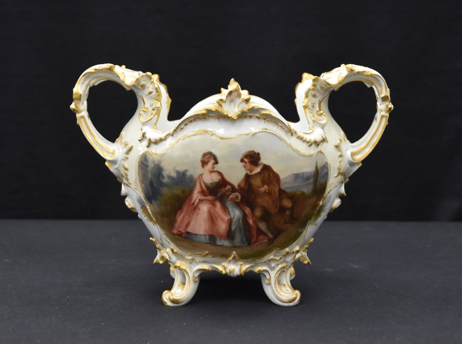 KPM HAND PAINTED CENTERPIECE: HAND PAINTED KPM PORCELAIN TWIN HANDLE CENTER PIECE WITH ROMANTIC SCENES ON BOTH SIDES - 11" x 9" x 8 1/2'"