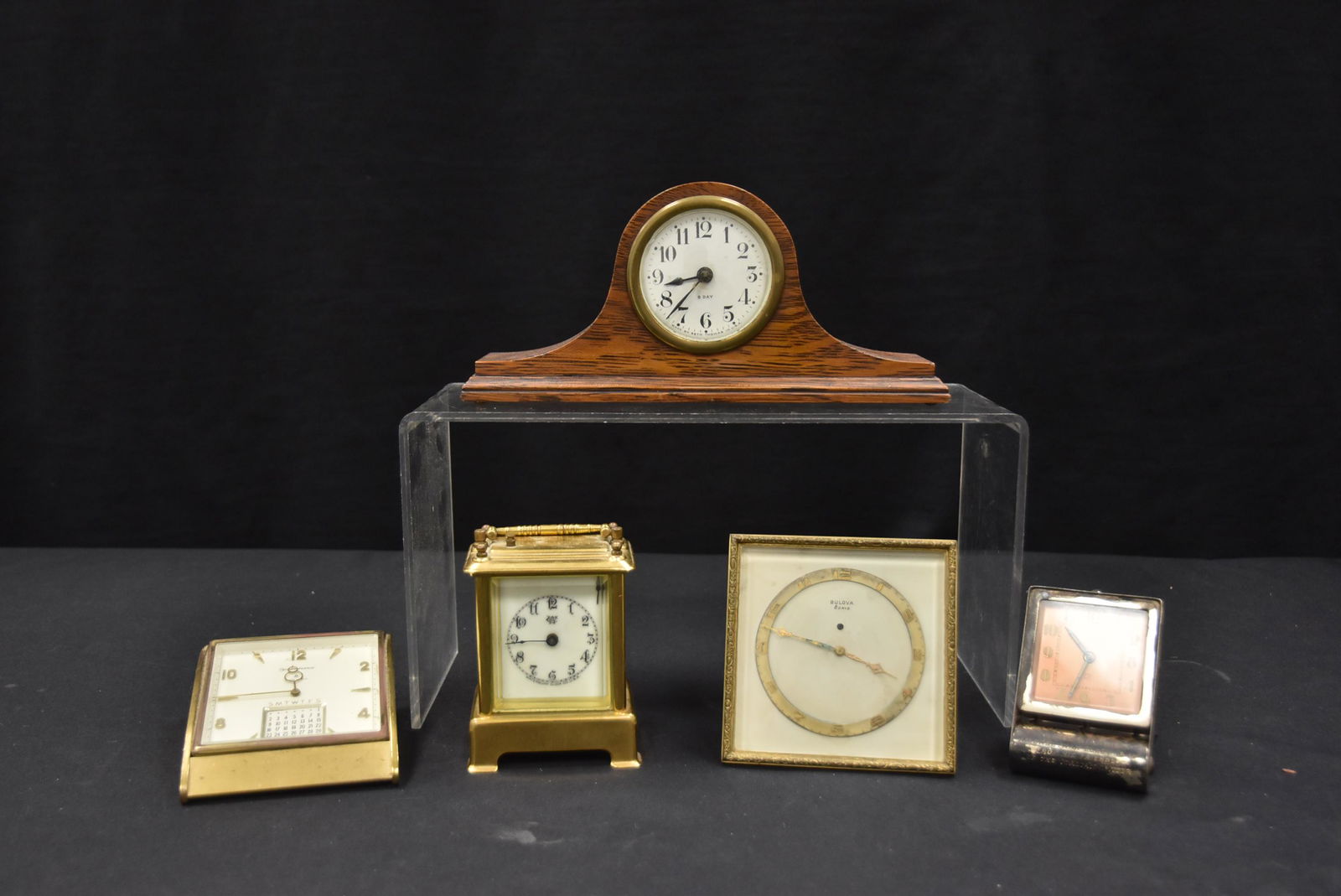 (5) ASSORTED CLOCK TO INCLUDE: WATERBURY CARRIAGE CLOCK , SETH THOMAS TAMBOUR CLOCK , LeCOULTRE TRAVEL CLOCK , BULOVA ALARM CLOCK & REMEMBERANCE CALENDAR CLOCK - LARGEST IS 9" x 2" x 4"