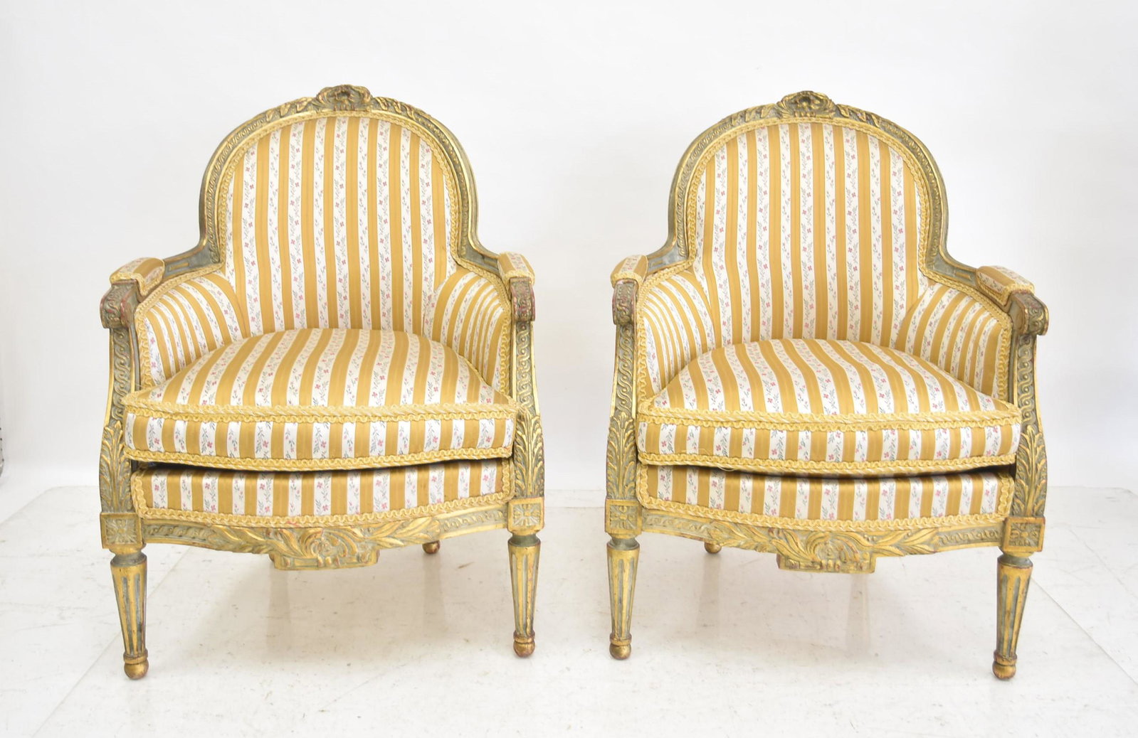 (Pr) ANTIQUE FRENCH LXVI STYLE BERGERE CHAIRS: (Pr) ANTIQUE FRENCH GILTWOOD BERGERE CHAIRS WITH FINE STRIPED UPHOLSTERY - 26" x 28" x 34"