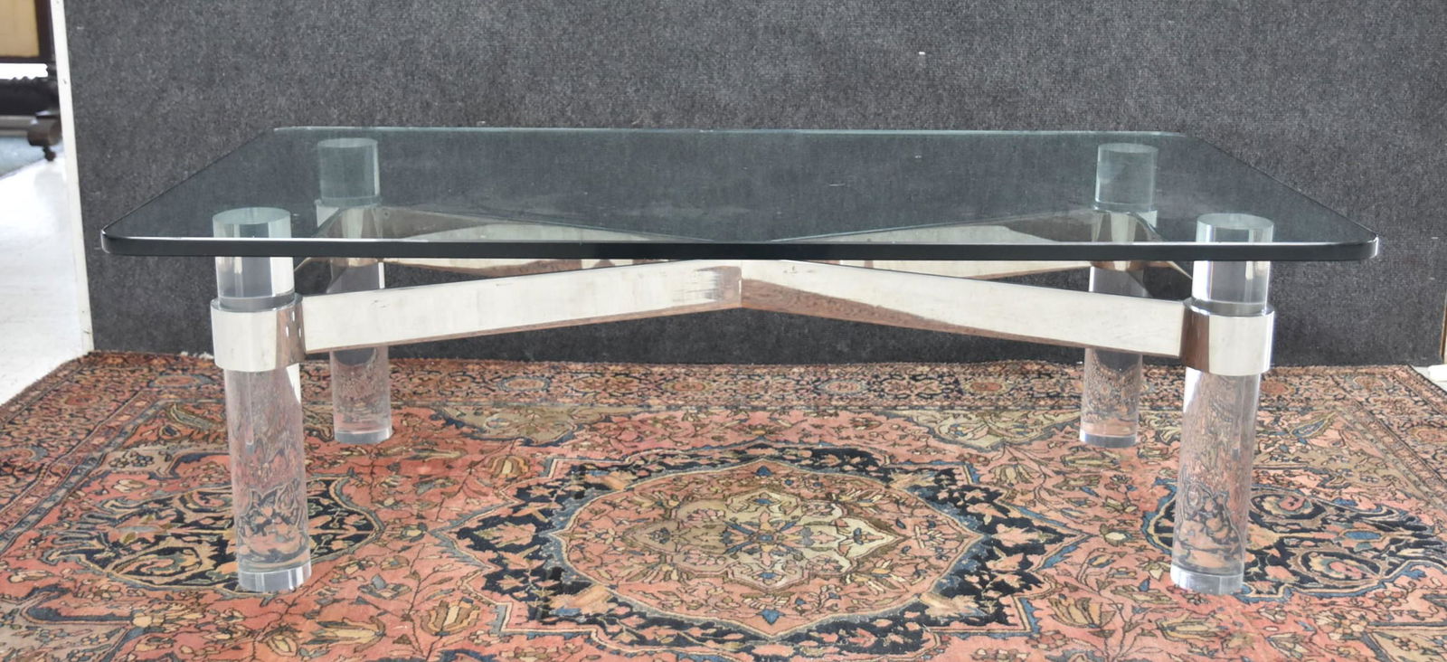 KARL SPRINGER STYLE LUCITE & SILVERED COFFEE TABLE: GLASS TOP COFFEE TABLE WITH LUCITE & SILVERED METAL BASE - 49 1/2" x 26" x 16" (GLASS HAS CHIP)