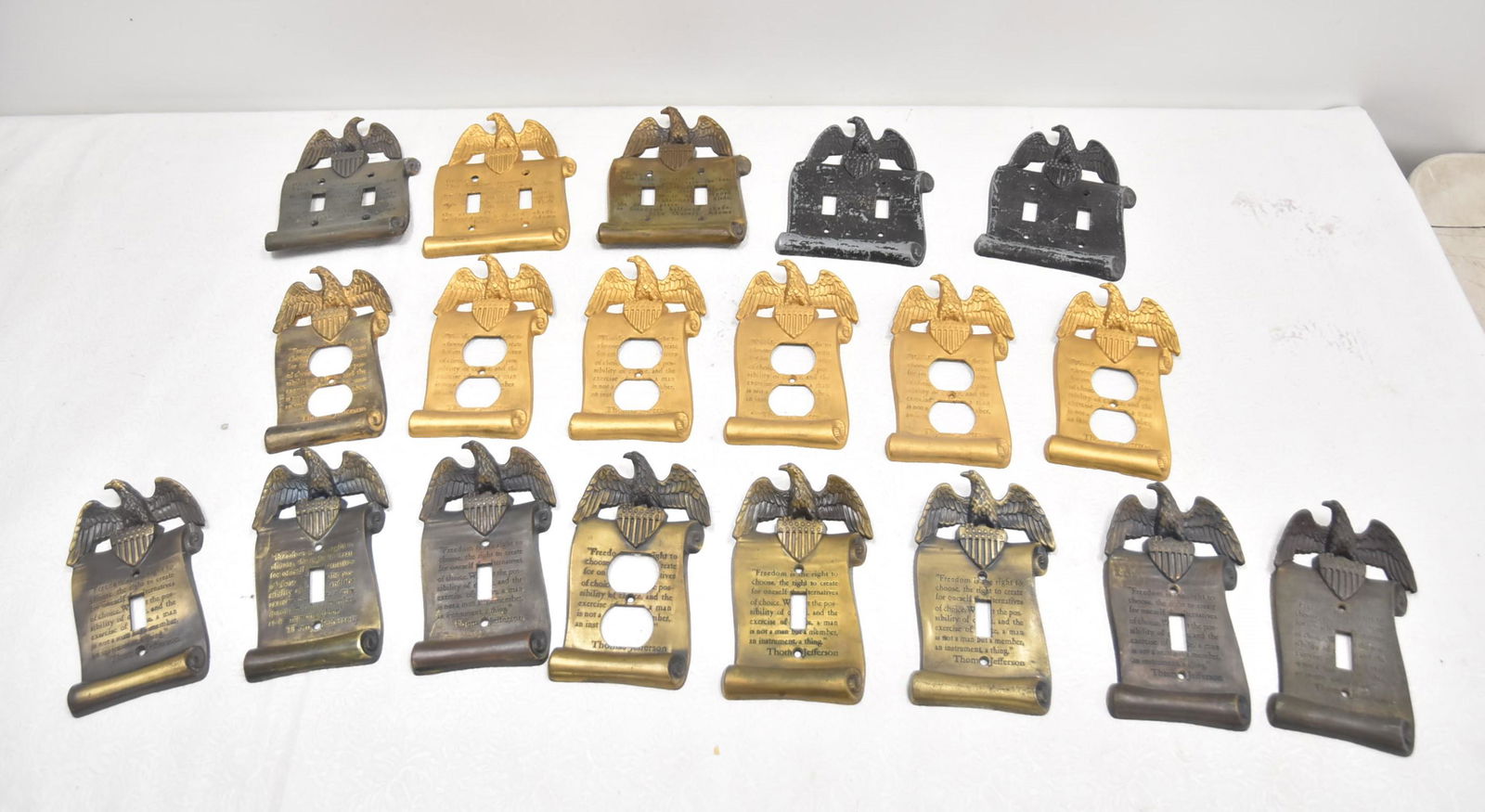 (17) COLONIAL BRASS FINISH ELECTRICAL WALL PLATES: INCLUDING SOME DOUBLE SWITCH AND SOME SINGLE PULL ; WITH PRESIDENTIAL SAYINGS BY THOMAS JEFFERSON & JOHN QUINCY ADAMS - LARGEST IS 5" x 6 1/2"