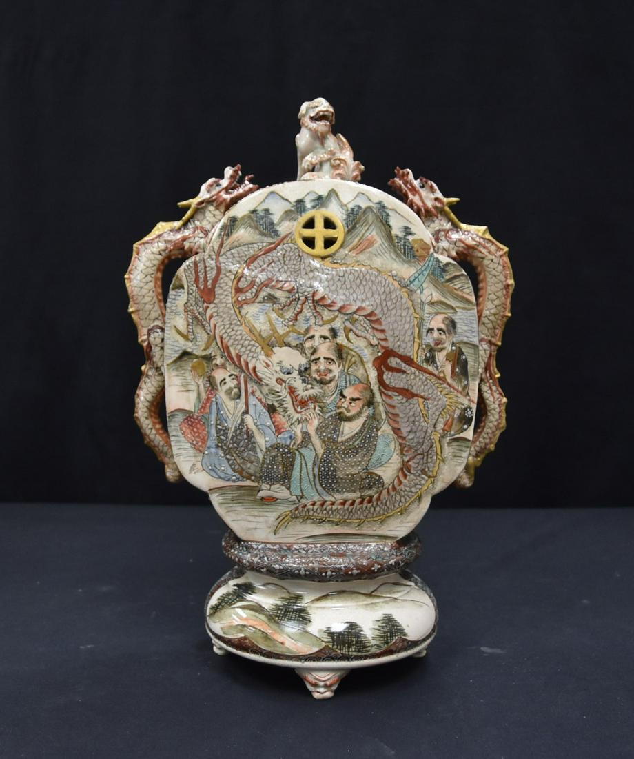 SATSUMA MOON FLASK KORO: SATSUMA , MEIJI PERIOD KORO INCENSE BURNER WITH LARGE DRAGON HANDLES DECORATED WITH SCHOLARS IN LANDSCAPE & LARGE DRAGON BEING RAISED ON (3) TAPERED MASKED FEET & FOO DOG LID , SIGNED SATSUMA SEI - 10