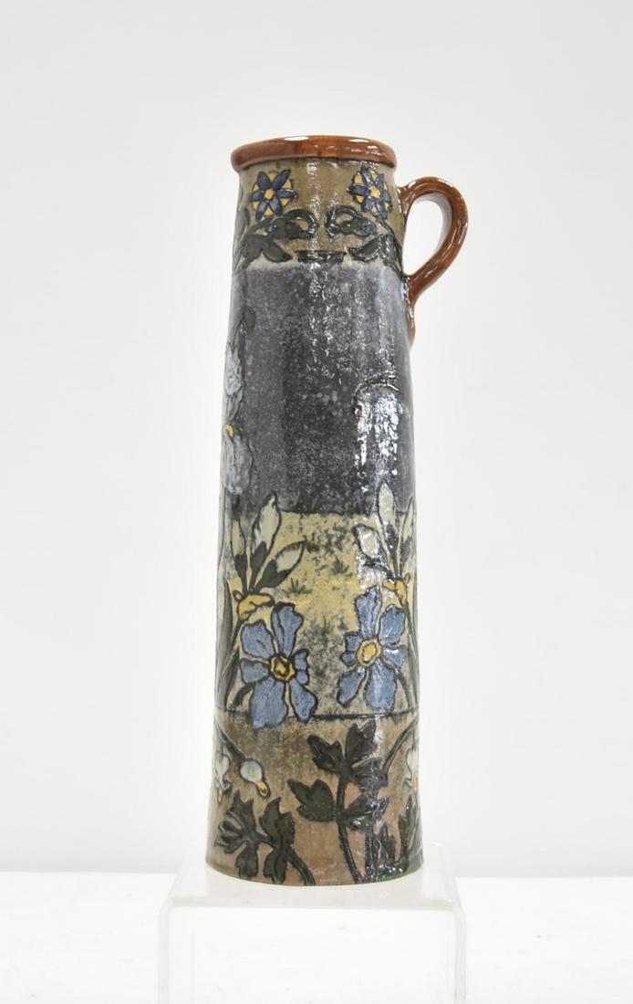 FREDERICK HURTEN RHEAD TANKARD: STC & P (STEIGER , TERRACOTTA & POTTERY WORKS TANKARD BY FREDERICK HURTEN RHEAD WITH CUERDA SECA DESIGN SURROUNDED BY ENGRAVED FLOWERS , SIGNED STC & P ; WITH INITIALS FHR , DATED 1913 IN WHICH THE TI