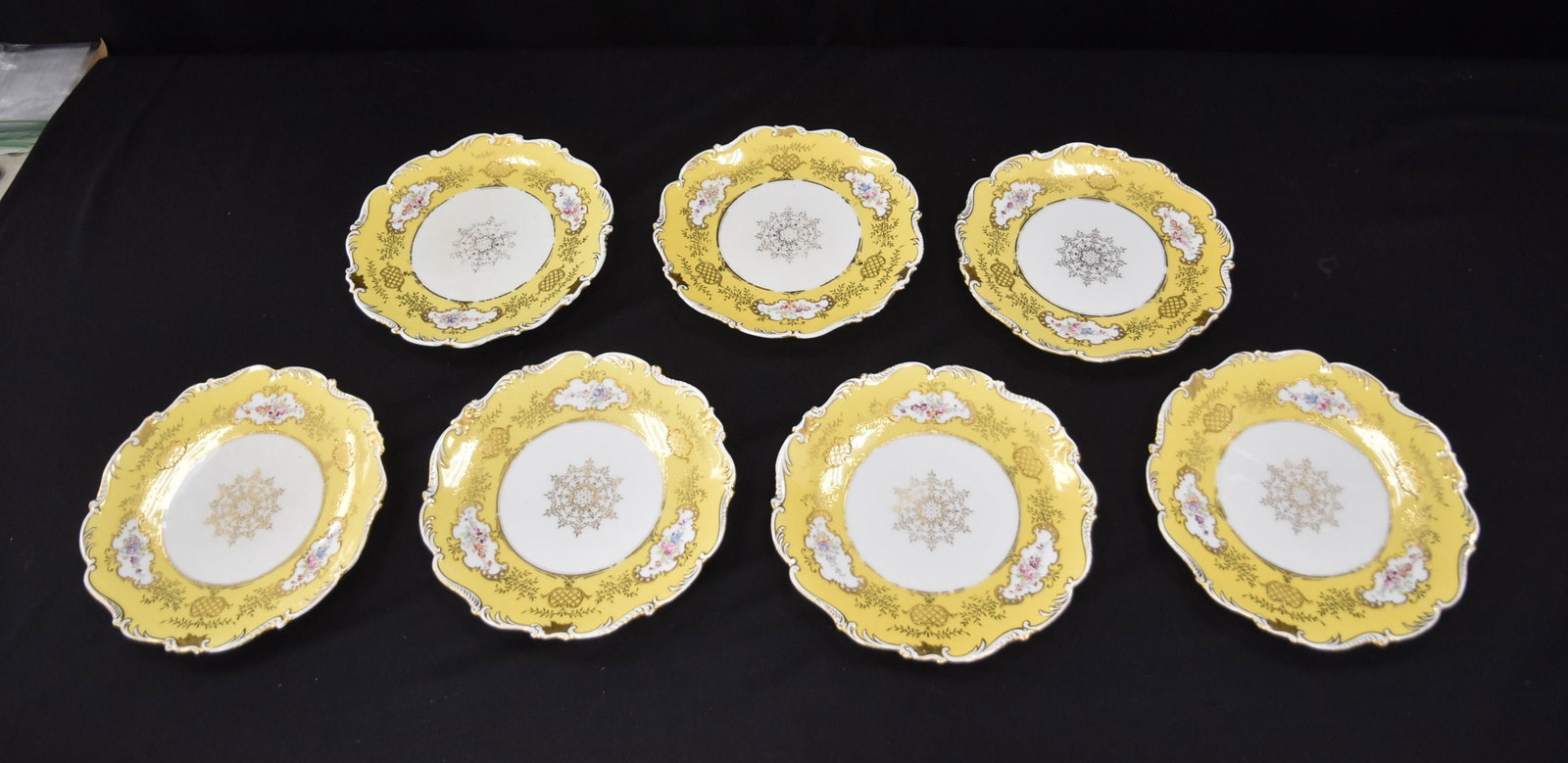 (7) COALPORT ENGLAND PORCELAIN SERVICE PLATES: (7) COALPORT PORCELAIN DINNER PLATES WITH FLORAL MEDALLIONS SURROUNDED BY YELLOW BORDER - 9"