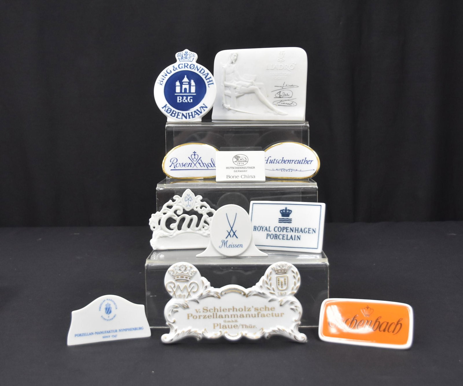 (11) PORCELAIN DEALER PLAQUES: TO INCLUDE (2) HUTSCHENREUTHER DEALER PLAQUES / ROYAL COPENHAGEN DEALER PLAQUE / BING & GRONDAHL COPENHAGEN DEALER PLAQUE / MEISSEN DEALER PLAQUE / ROSENTHAL DEALER PLAQUE / LLADRO DEALER PLAQUE / ESC