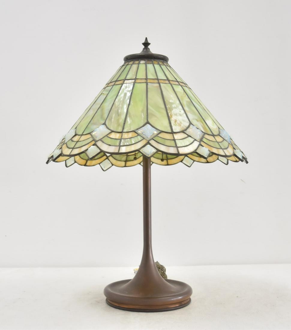 2-TONE LEADED GLASS TABLE LAMP: 2-TONE LEADED GLASS SHADE TABLE LAMP WITH PATINATED BASE - SHADE IS 17 1/2" x 9 1/2" ; OVERALL IS 17 1/2" x 21" (FEW CRACKS IN SHADE)