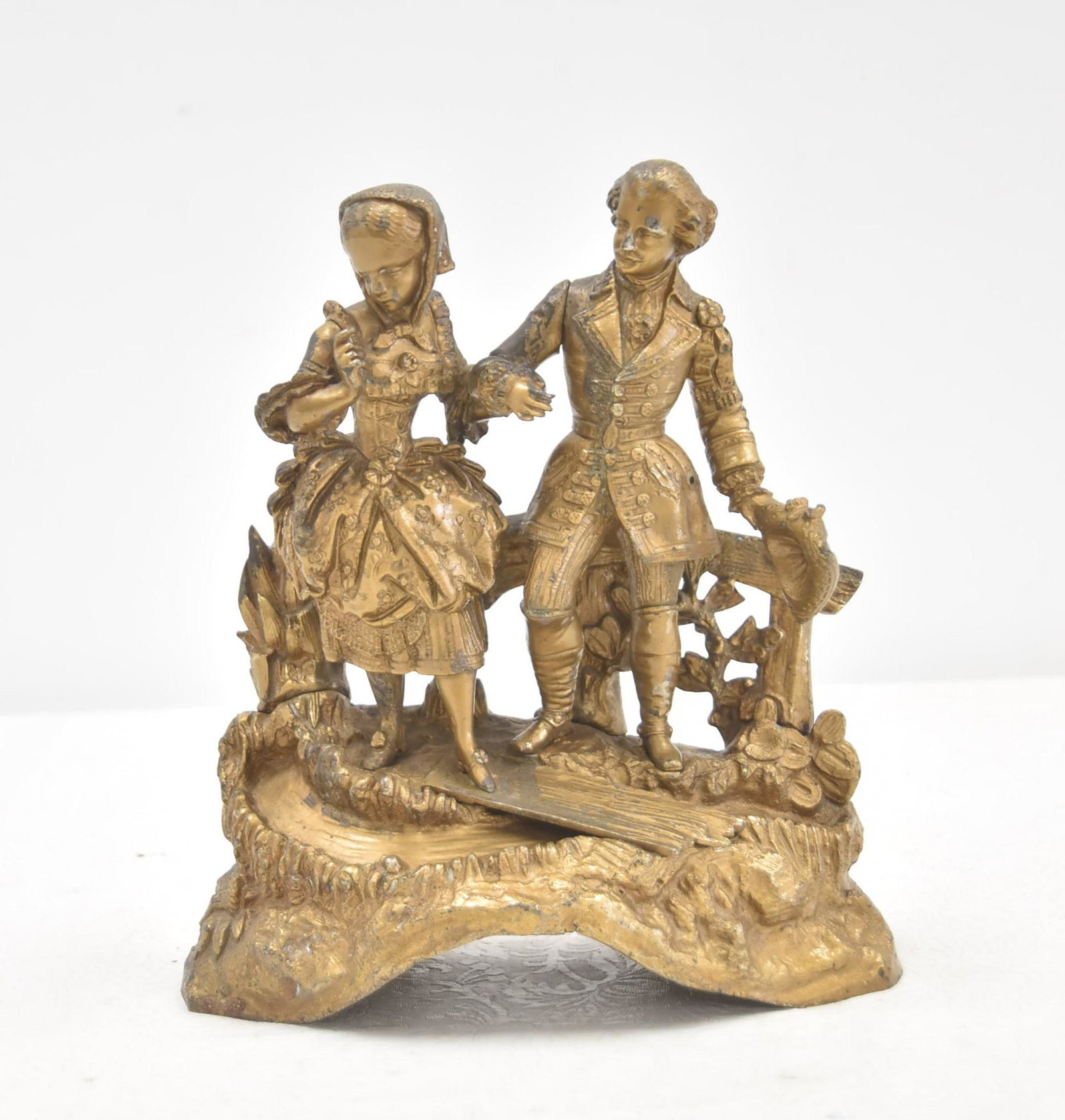 GILDED METAL SECTIONAL GROUPING: SECTIONAL GILDED METAL GROUPING OF COUPLE ON ROCK FORM BASE - 8" x 3 1/2" x 9"