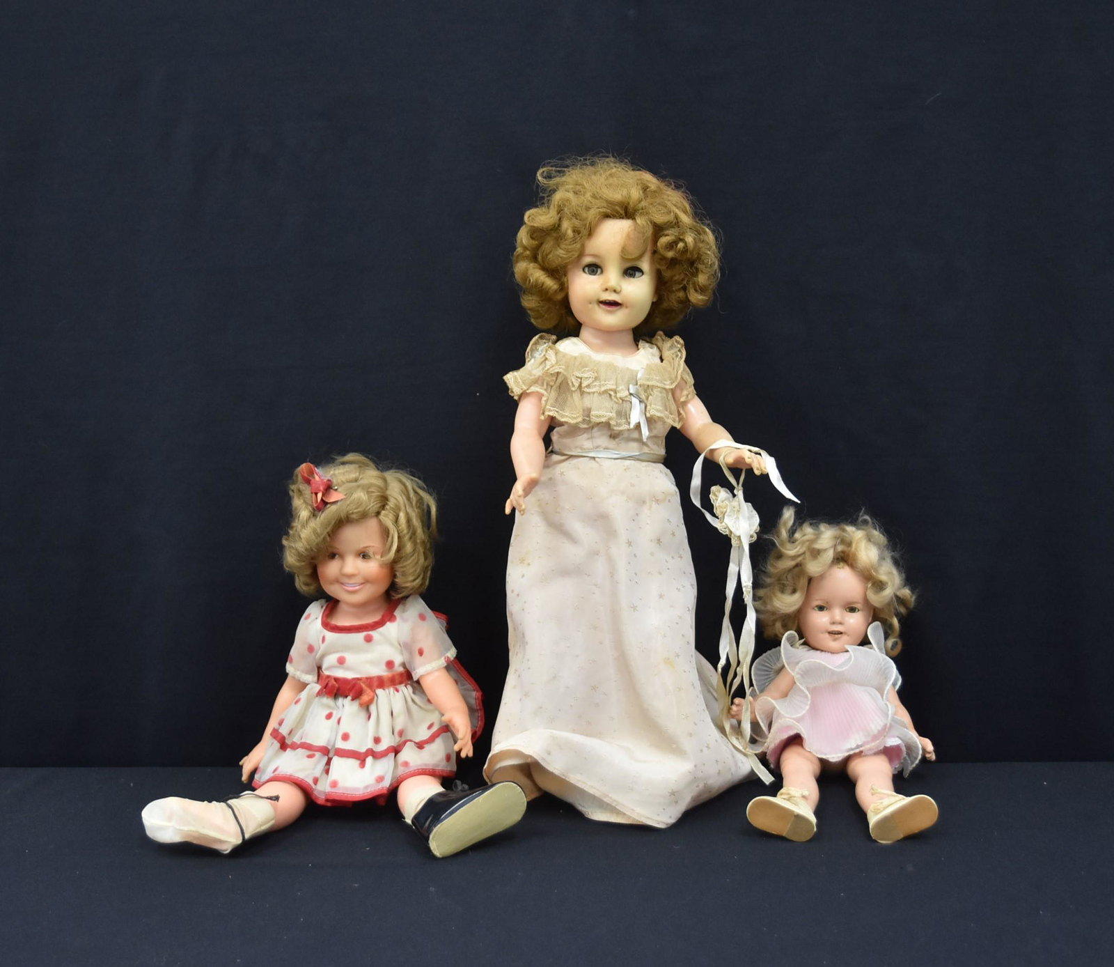 (3) VINTAGE SHIRLEY TEMPLE DOLLS: IDEAL SHIRLEY TEMPLE DOLL / COMPOSITION SHIRLEY TEMPLE DOLL / VINYL SHIRLEY TEMPLE DOLL - LARGEST IS 18" TALL