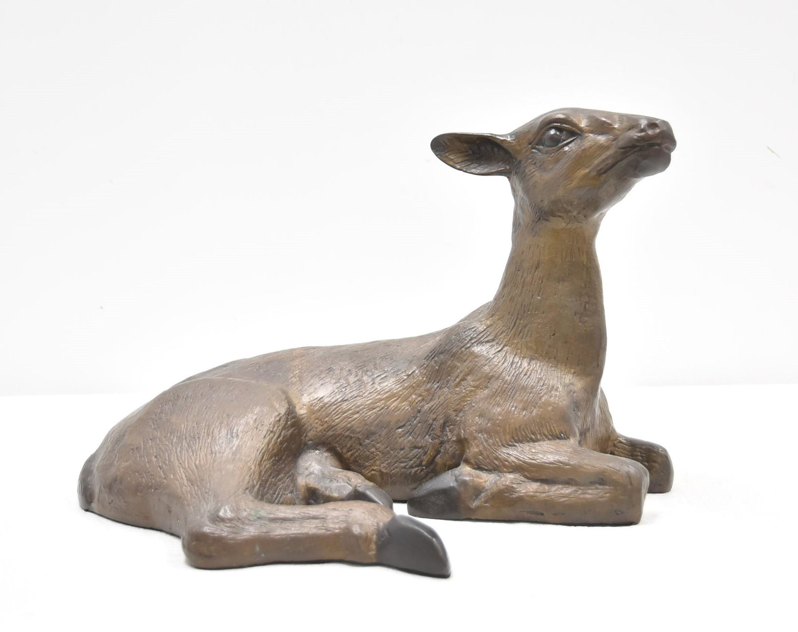 BRONZE RECLINING DEER: BRONZE RECUMBANT DEER - 16 1/2" x 12" x 11"