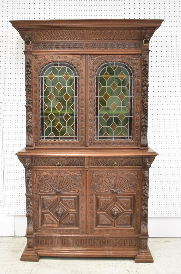 ANTIQUE CARVED OAK & LEADED GLASS HUTCH: ANTIQUE CARVED OAK CABINET WITH CARVED FRUIT & LION HEADS WITH (2) LEADED GLASS DOORS - 50" x 19" x 87" (MISSING FEW MOLDINGS)