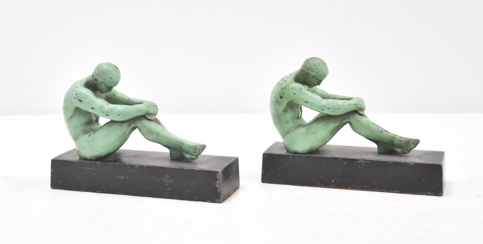 (Pr) ART DECO MALE NUDE BOOKENDS: (Pr) VERDIGRIS PATINATED METAL ART DECO BOOKENDS OF RECLINING MALE NUDES - 7 1/2" x 2 1/2" x 5 1/2"