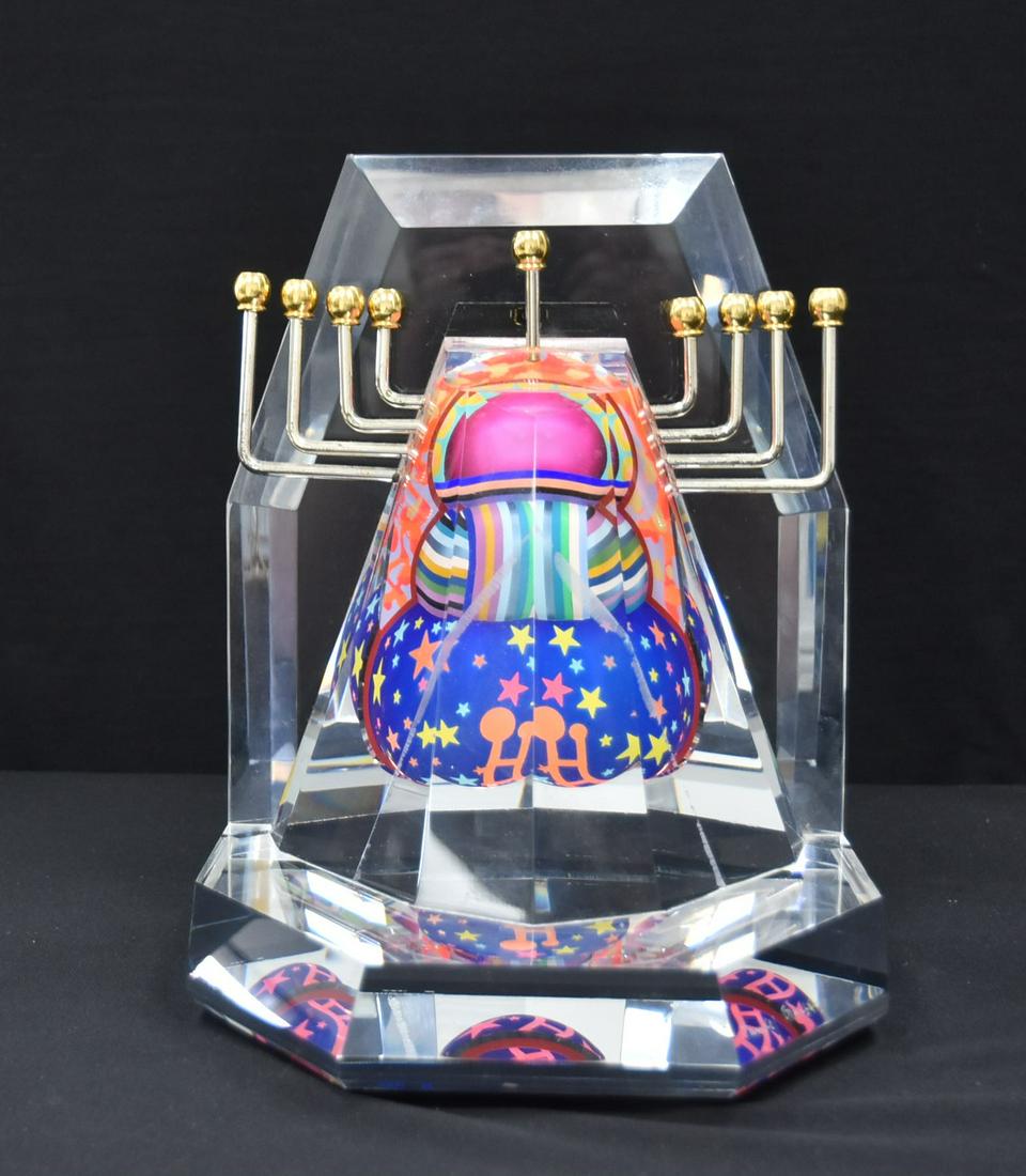 YANKEL GINZBURG , ACYRLIC LUCITE MENORAH: YANKEL GINZBURG (AMERICAN, b. 1945) JUDAICA ACRYLIC LUCITE CHANUKAH MENORAH WITH SCREEN PRINTED DESIGNS , SIGNED YANKEL GINZBURG - 10" x 9" x 11 1/2" (HAS LINE IN LUCITE)