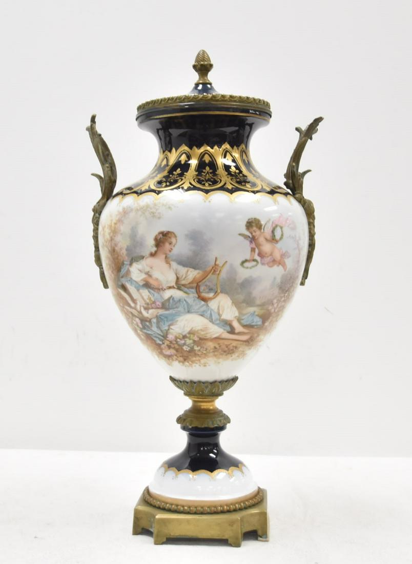 LARGE SEVRES PORCELAIN COVERED URN: LARGE SEVRES PORCELAIN COVERED URN WITH CLASSICAL WOMAN HOLDING LYRE SURROUNDED BY CHERUBS & LANDSCAPES , ARTIST SIGNED POITEVIN ; HAVING BRONZE MOUNTS - 11" x 24" (HAS HAIRLINE ON SIDE & REPLACED COV