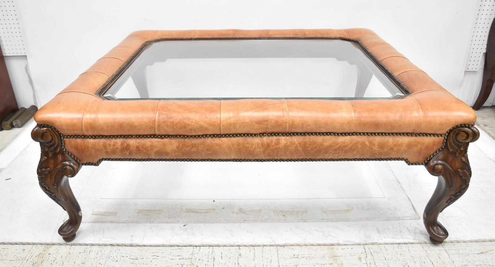 MAITLAND LEATHER MOUNTED COFFEE TABLE: MAITLAND SMITH LEATHER MOUNTED COFFEE TABLE WITH EXPOSED NAILHEADS - 48" x 56" x 20" (MISSING BOTTOM RUNNERS)