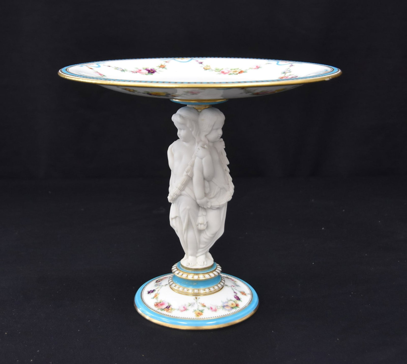 ENGLISH MINTON ? PORCELAIN TAZZA: ENGLISH UNSIGNED MINTONS PORCELAIN TAZZA WITH 3 GRACES HOLDING TAZZA DISH - 10" x 9"
