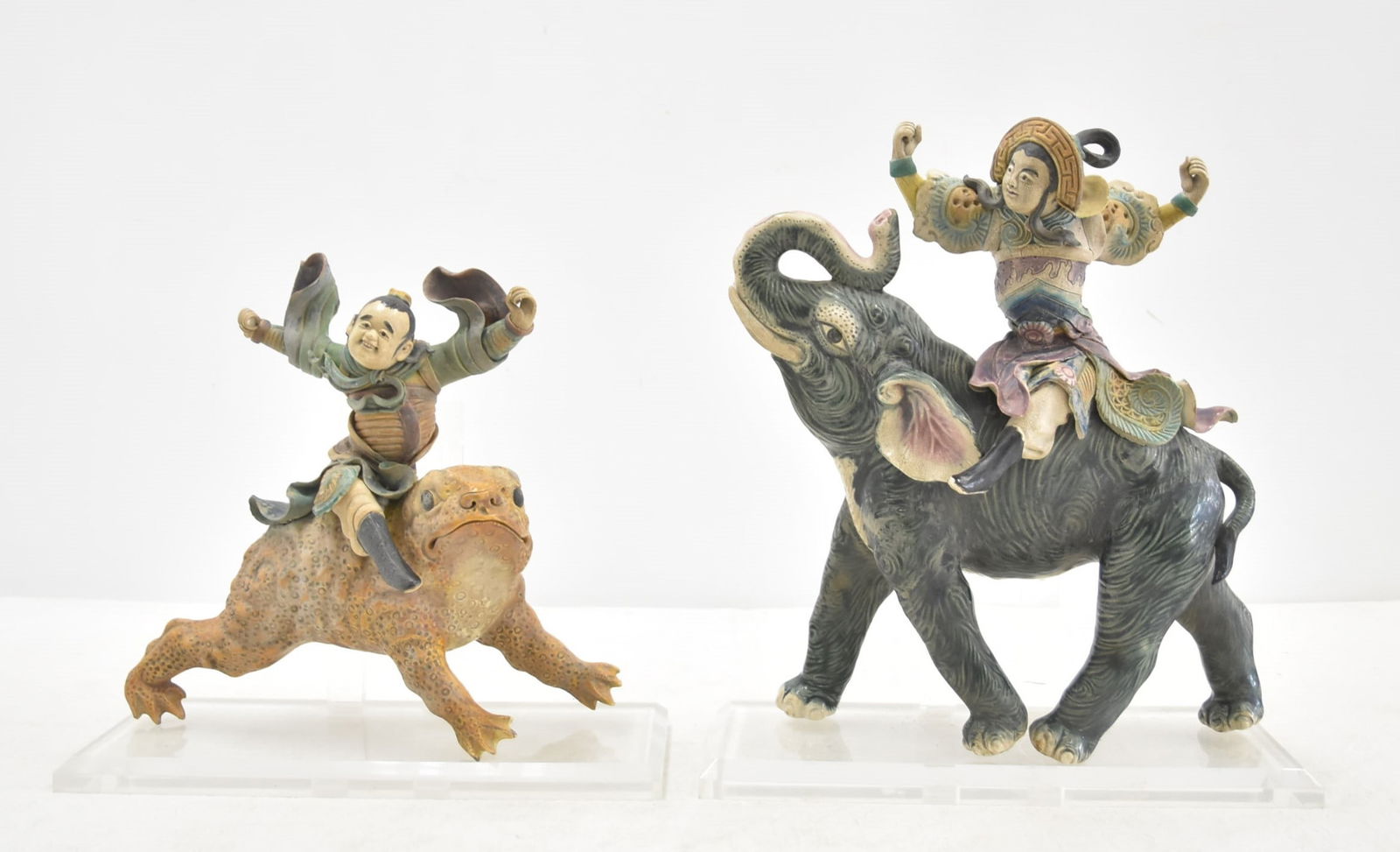 (2) CHINESE GLAZED CERAMIC ROOF TILES: POLYCHROME DECORATED CHINESE CERAMIC ROOF TILE OF WARRIOR MAN RIDING ELEPHANT , MOUNTED TO ACRYLIC BASE / CHINESE POLYCHROME DECORATED CERAMIC ROOF TILE OF SOLDIER WARRIOR RIDING A TOAD , MOUNTED TO A