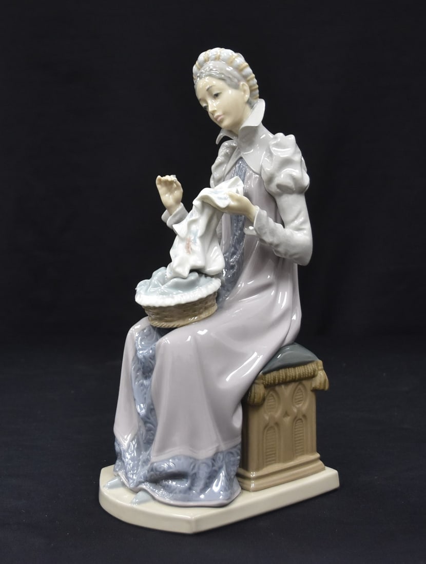 LLADRÓ "SEWING A TROUSSEAU": LLADRÓ MODEL # 5126 , "SEWING A TROUSSEAU" Spanish Name: Bordando El Ajuar , Sculptor: Salvador Furió , ISSUED 1982 , RETIRED 1989 - 4 1/2" x 5 1/2" x 12"