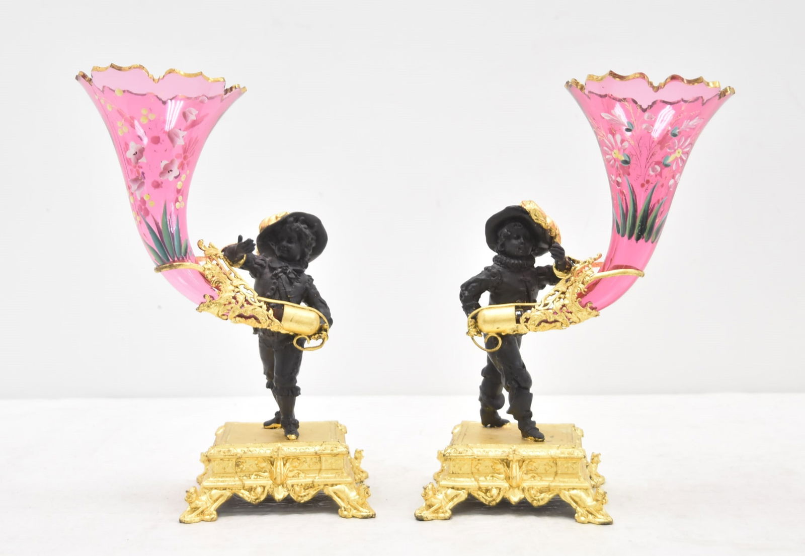 (Pr) ENAMELED CRANBERRY GLASS FIGURAL EPERGNES: (Pr) GILDED & PATINATED METAL FIGURAL EPERGNES WITH FIGURES HOLDING FLORAL ENAMELED GLASS CORNACOPIA EPERGNES - 7" x 4 1/2" x 11"