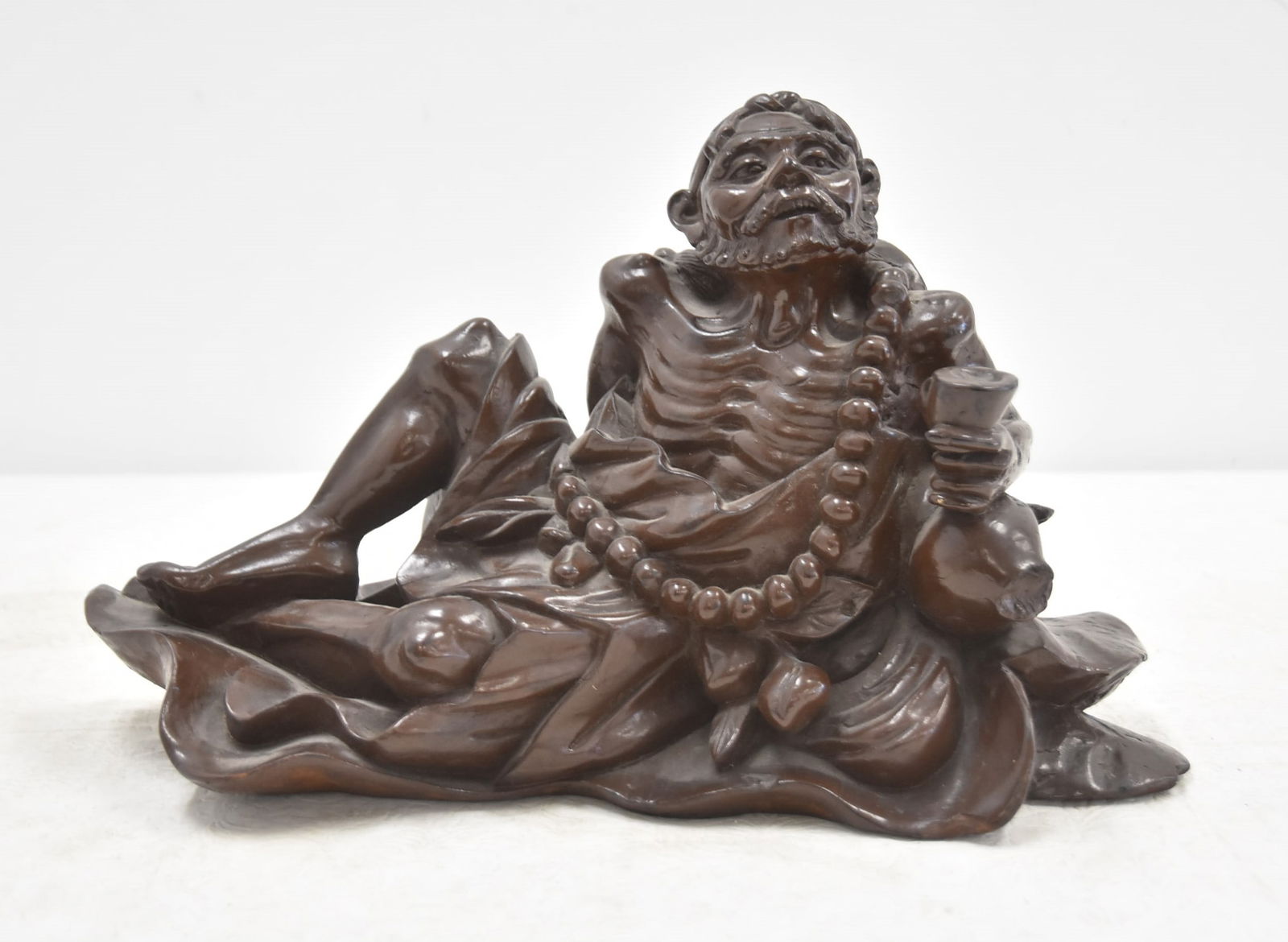 CHINESE WOOD CARVING OF RECUMBANT MAN: ANTIQUE CHINESE WOOD CARVING OF RECLINING MAN - 14 x 5" x 8 1/2"