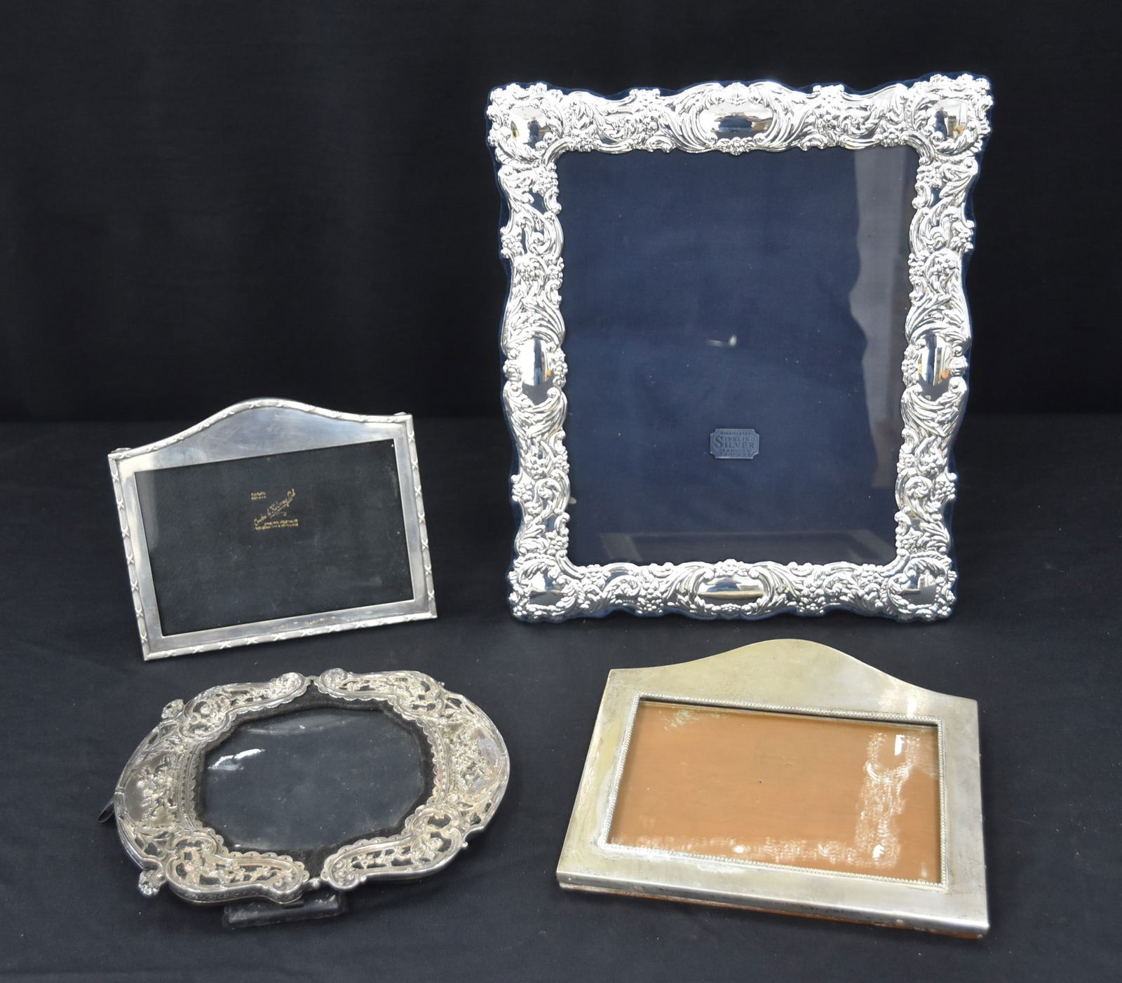 (4) STERLING SILVER FRAMES: CARRS OF SHEFFIELD STERLING SILVER MOUNTED PICTURE FRAME - 11" x 12 1/2" OVERALL / EMBOSSED STERLING PICTURE FRAME WITH EMBOSSED CHERUBS / (2) ENGLISH STERLING PICTURE FRAMES