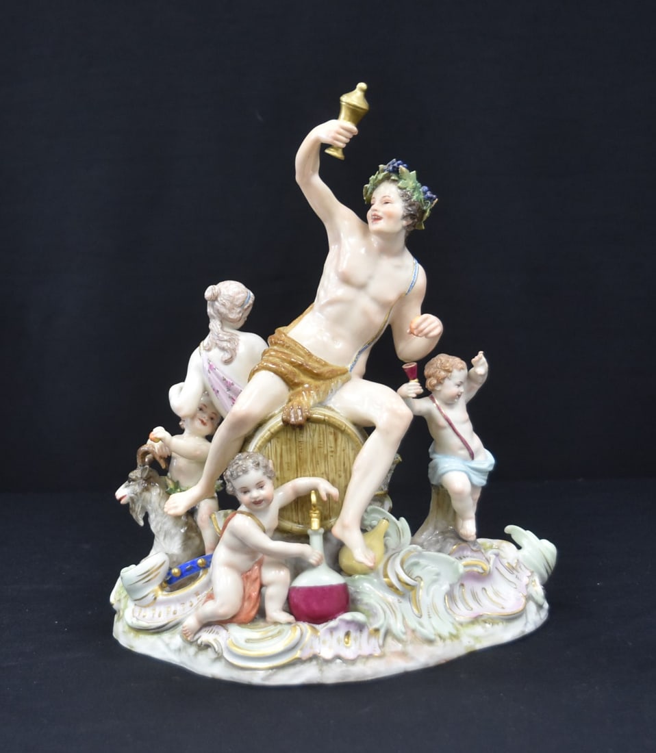 LARGE MEISSEN BACCHUS FIGURAL GROUPING: LARGE MEISSEN PORCELAIN BACCAHANAL GROUPING DEPICTING BACCHUS TOASTING WINE SEATED ON WINE JUG SURROUNDED BY NYMPH , YOUNG SATYR & CHERUBS , INCISED MODEL 2202 - 10" x 7" x 11"