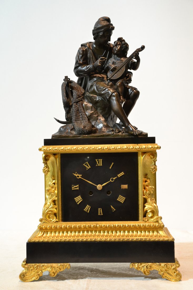 19thC DORE & PATINATED BRONZE CLOCK WITH BRONZE: MAN & GIRL WITH MANDOLIN SCULPTURE ATOP (MOVEMENT HAS STOPPED WORKING) PENDULUM DOESNT SEEM TO FIT CORRECTLY) 13" x 6" x 23"