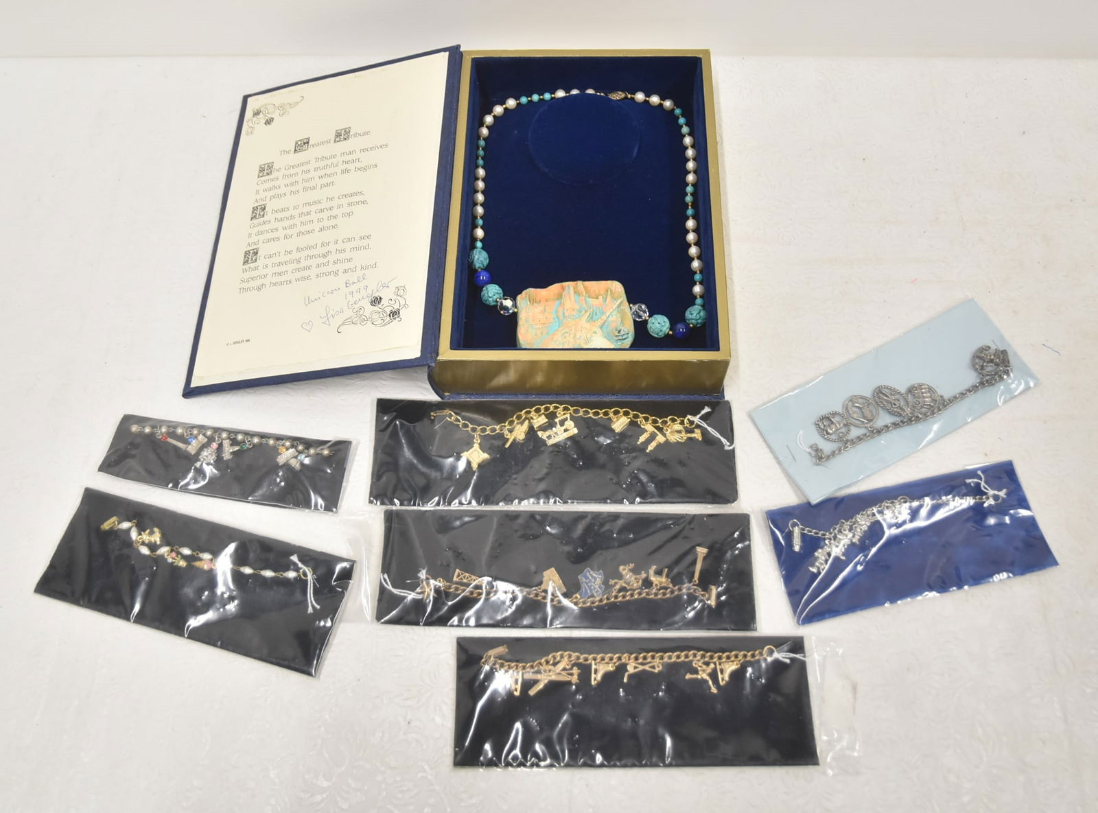 (7) COSTUME CHARM BRACELETS & NECKLACE: (7) COSTUME JEWELRY CHARM BRACELETS ./ UNICRON BALL BY LISA GEUGLES IN BOOKFORM BOX , 1999