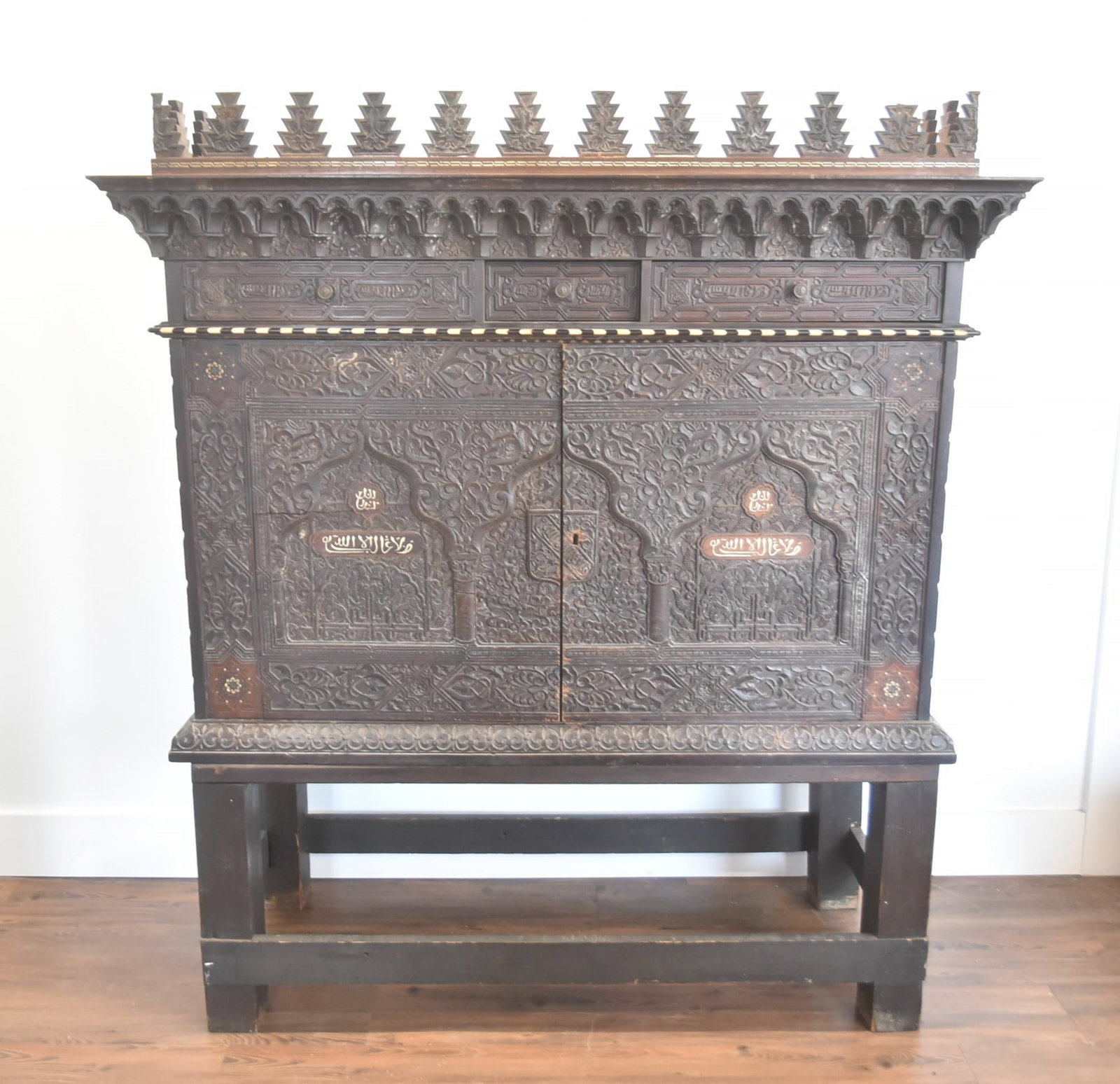 18th - 19thC MIDDLE EASTERN SECRETARY CABINET: 18th - 19th CENTURY MIDDLE EASTERN SYRIAN - MOROCCAN SECRETARY CABINET WITH BONE INLAID DESIGNS & ISLAMIC INSCRIPTIONS - 53" x 22" x 60" (SOME REPAIR TO DOOR & FINIALS )