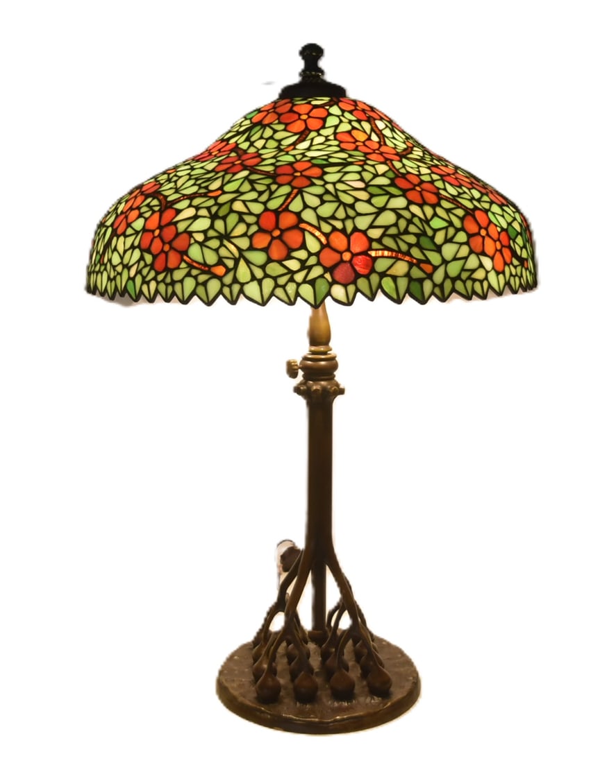 LARGE DOGWOOD PATTERN LEADED GLASS TABLE LAMP: LARGE ATTRIBUTED TO HANDEL DOGWOOD PATTERN LEADED GLASS SHADE TABLE LAMP WITH LATER ADJUSTABLE BRONZE TIFFANY STUDIOS STYLE BASE - SHADE IS 23" x 10" ; OVERALL IS 23" x 35" ; ADJUSTS TO 38" TALLfew li