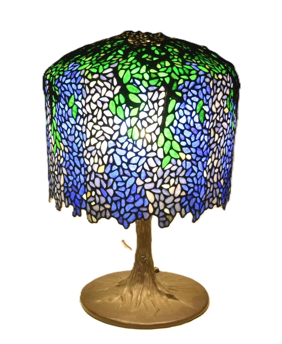 FINE TIFFANY STUDIOS STYLE WISTERIA LAMP: ATTRIBUTED TO AZALEA LAMP STUDIOS FINE TIFFANY STUDIOS STYLE LEADED GLASS WISTERIA TABLE LAMP ; WITH FULL WISTERIA LEADED GLASS SHADE ; ON BRONZE TREE TRUNK FORM BASE - SHADE IS 19" x 16 1/2" ; 16 1/2