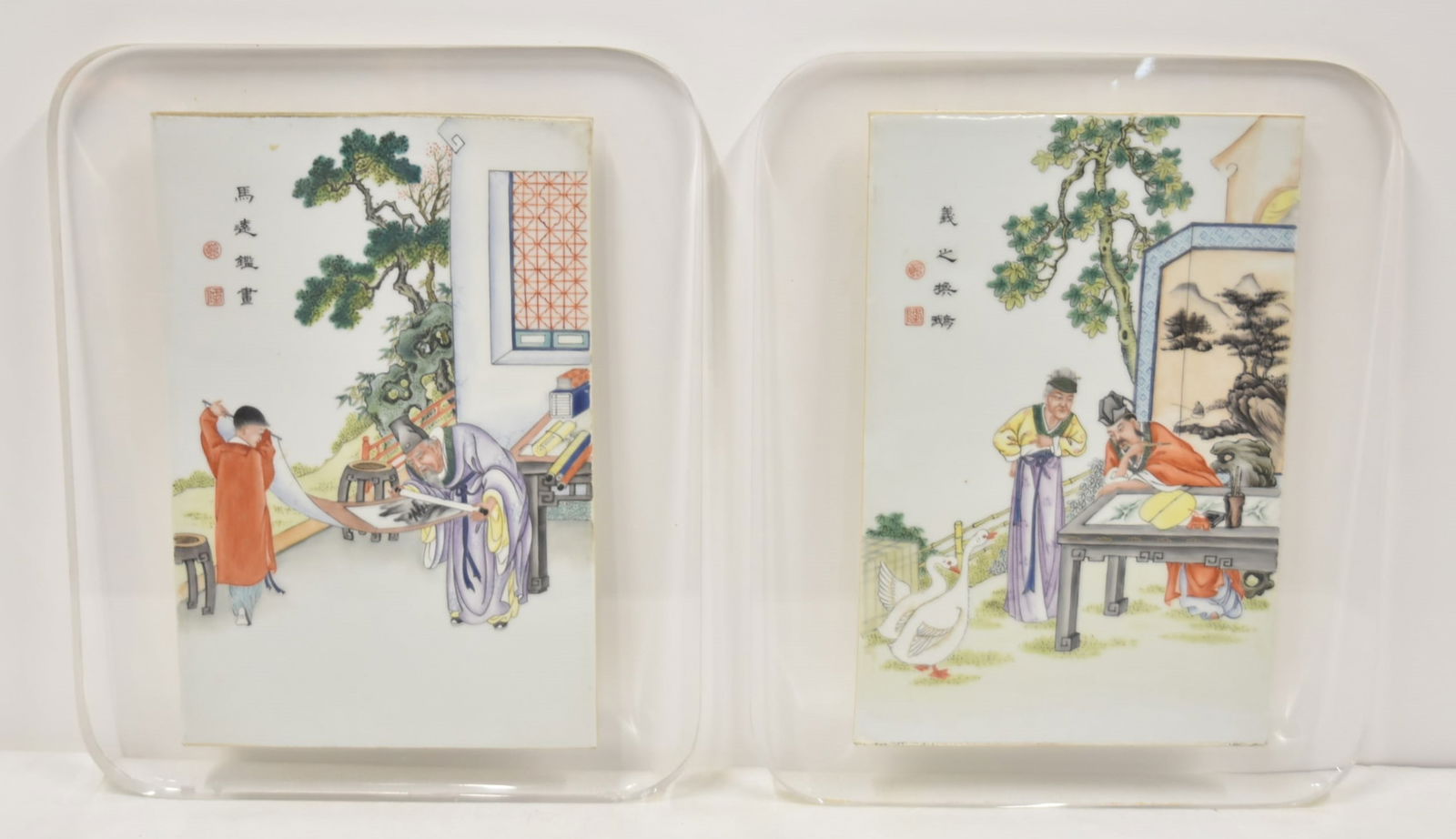 PAIR OF CHINESE PORCELAIN PORCELAIN TILE PLAQUES: PAIR OF CHINESE HAND PAINTED ENAMEL PORCELAIN TILE PLAQUES WITH SCROLL ARTIST FIGURES , SIGNED , MOUNTED ON LUCITE FRAMES - TILE PLAQUES ARE 10" x 15" ; OVERALL FRAMED IS 15" x 18"