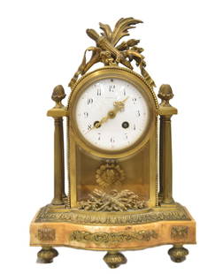 TIFFANY & Co. BRONZE & MARBLE MANTEL CLOCK: TIFFANY & Co. FRENCH LXVI BRONZE & SIENA MARBLE MANTLE CLOCK ; WITH COLUMNS & ACORN FINIALS HAVING FLAME & ARROW CARTOUCHE, c>a 1890 - 9" x 5" x 14"