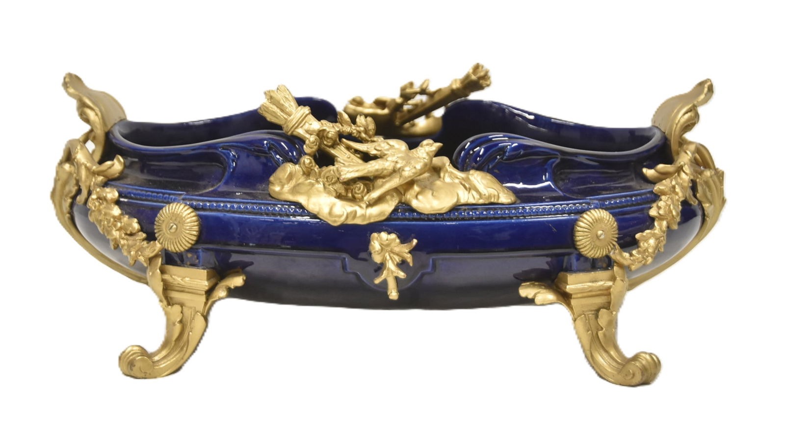 BRONZE MOUNTED COBALT PORCELAIN CENTERPIECE: FRENCH STYLE COBALT PORCELAIN CENTERPIECE BOWL WITH GILDED BRONZE MOUNTES ; ADORNED WITH BIRDS , TORCHES & FLORAL SWAGS - 16" x 11" x 6"