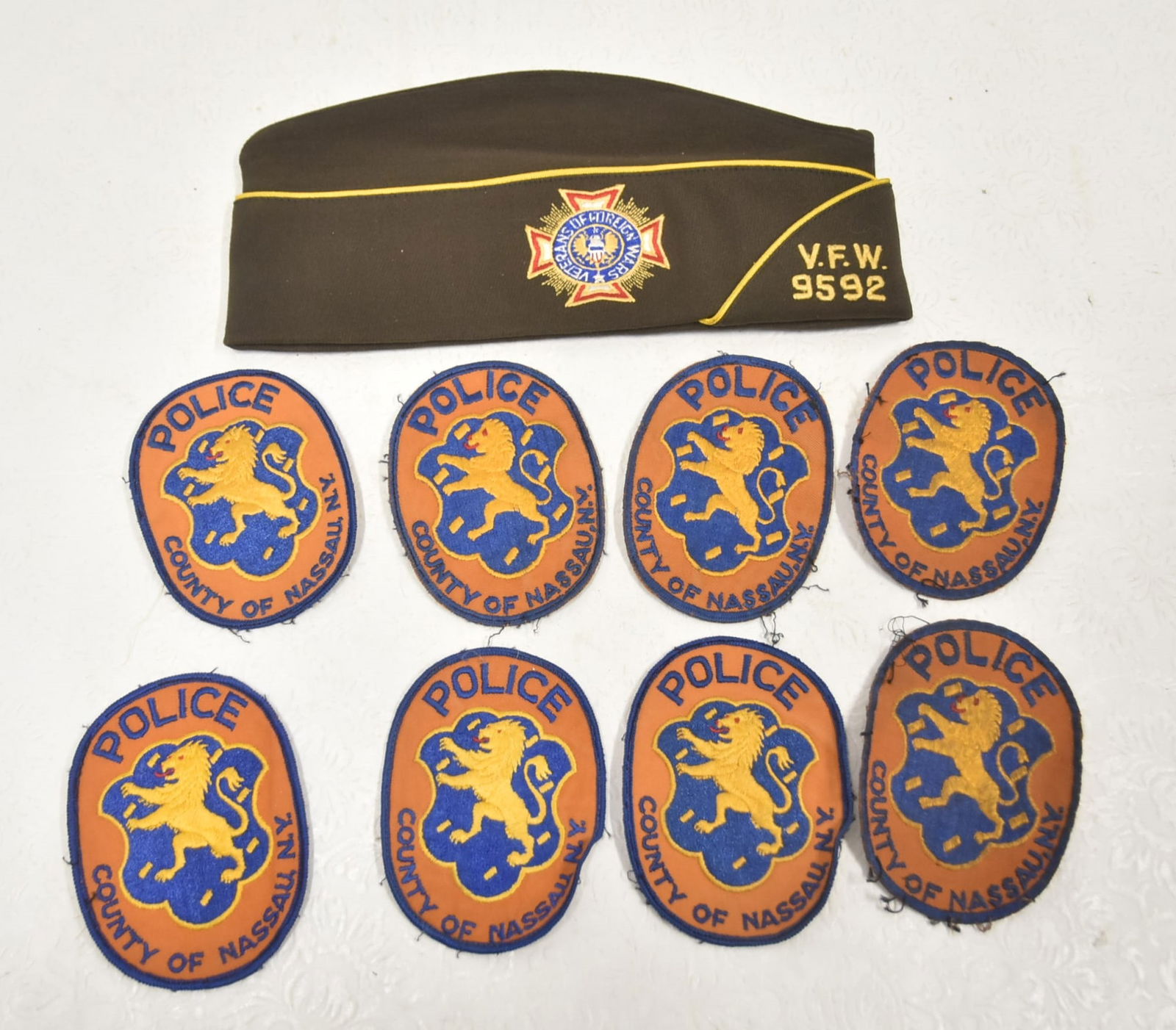 (8) NASSAU COUNTY POLICE PATCHES / VFW CAP: (8) VINTAGE NASSAU COUNTY POLICE PATCHES / VETERANS OF FOREIGN WARS CAP VFW 9592 ; 7 1/2" WITH QAURTERMASTER PIN