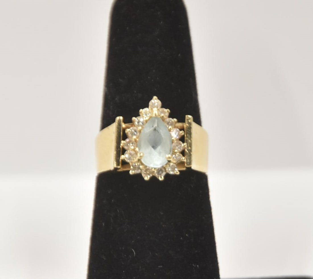 14kt PEAR SHAPE AQUA & DIAMOND HALO RING: 14kt GOLD PEAR SHAPE AQUA CENTER STONE SURROUNDED BY (15) DIAMOND CLUSTER HALO - 4.87grams ; SIZE 6 1/2