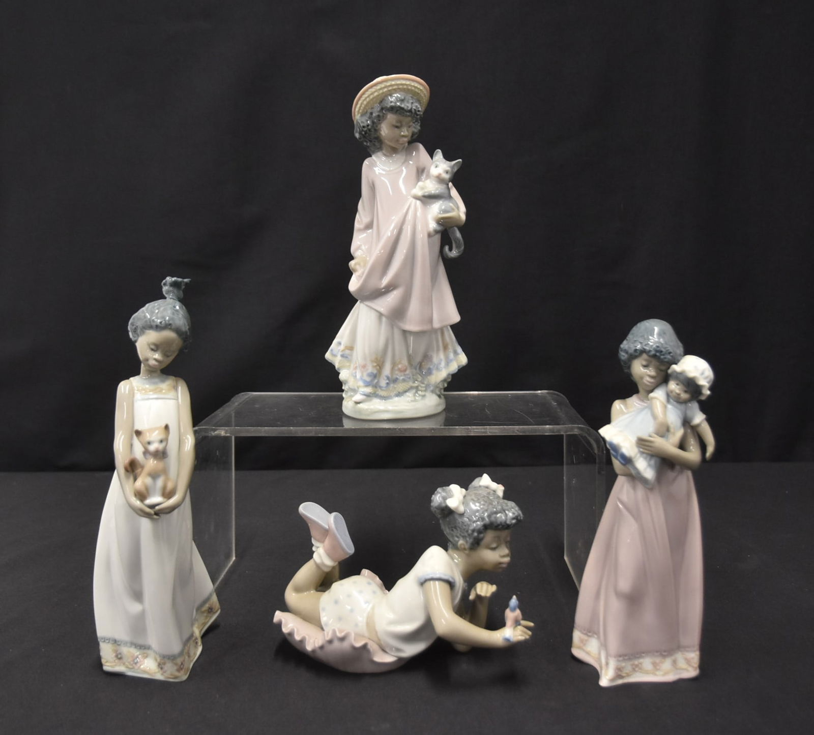 (4) LLADRO BLACK LEGACY FIGURINES: LLADRO 5837 BLACK LEGACY "SING WITH ME" PORCELAIN FIGURINE / LLADRO 5549 "MY NEW PET" BLACK LEGACY PORCELAIN FIGURINE / LLADRO 5608 "BABY DOLL" BLACK LEGACY PORCELAIN FIGURINE / LLADRO "CLOSE TO MY HE