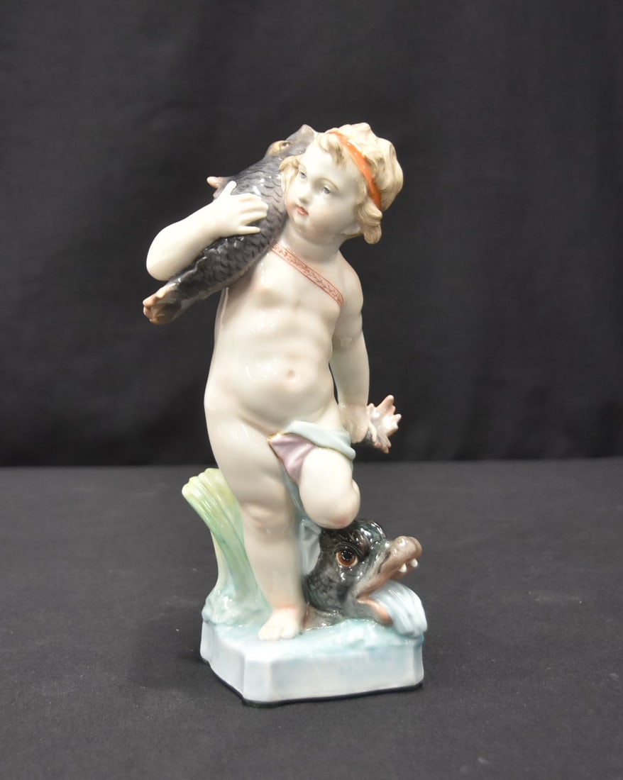 KPM BERLIN BOY WITH FISH & SERPENT: BERLIN KPM PORCELAIN FIGURINE OF PUTTO HOLDING CARP , STANDING ON SERPENT ; AFTER DESIGN BY WILHELM CHRISTIAN MEYER FOR ROYAL PORCELAIN MANUFACTURE BERLIN - 4" x 3 1/2" x 7 1/2"