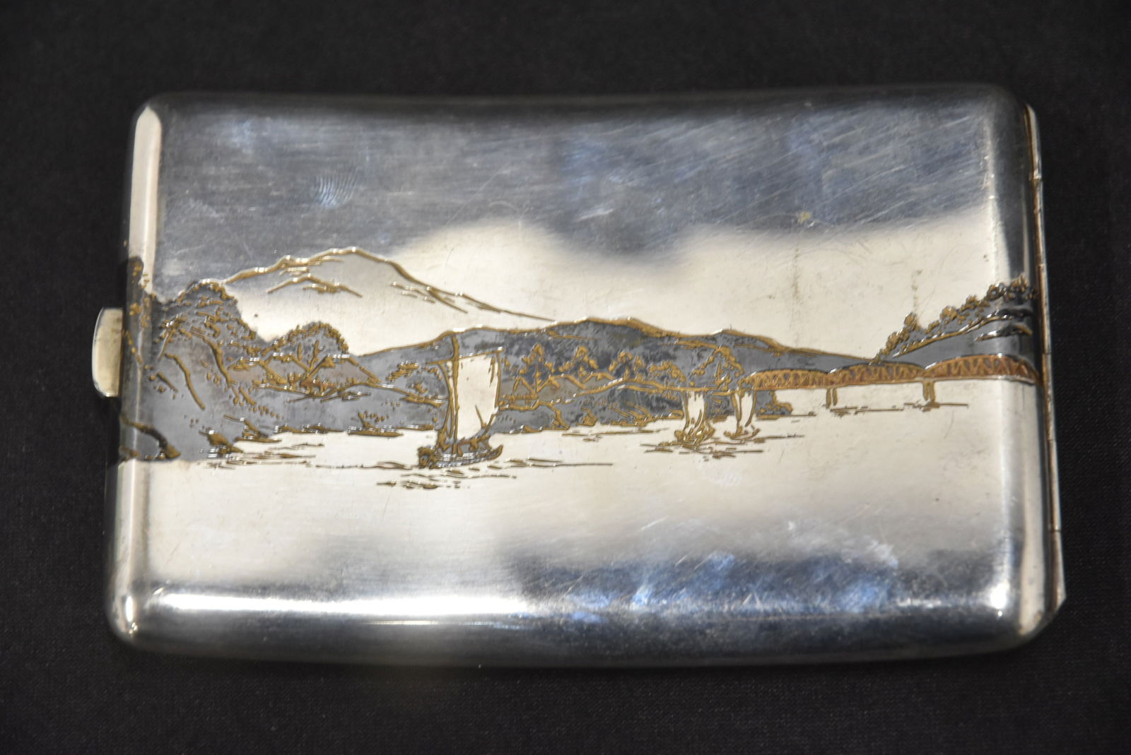 JAPANESE SILVER & NIELLO ENAMEL CIGARETTE CASE: LATE MEIJ PERIOD JAPANESE SILVER CIGARETTE CASE WITH NIELLO ENAMEL SHIPS & MOUNTAIN VIEWS - 5" x 3 34"