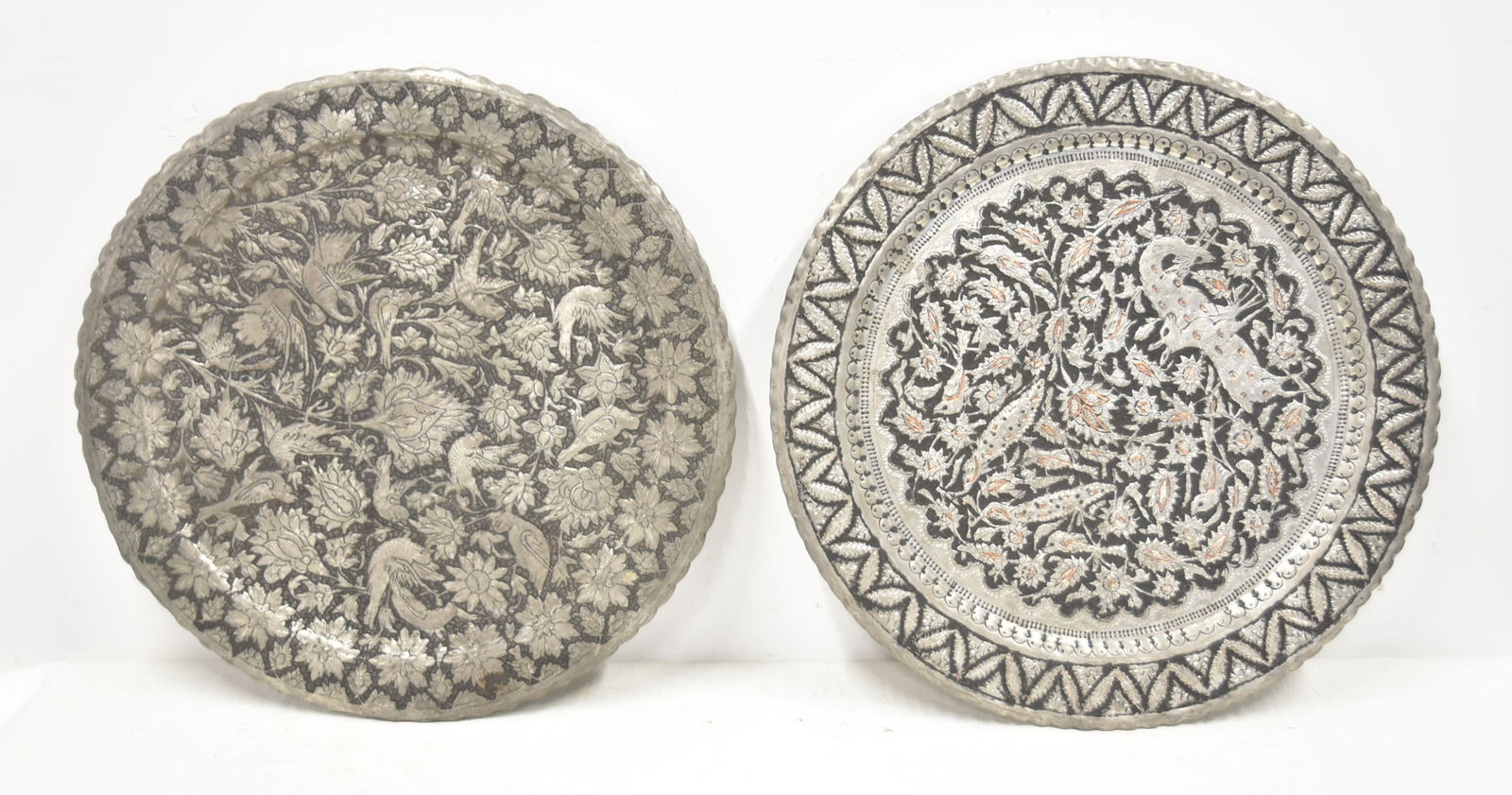 (2) HAND CHASED PERSIAN TRAYS: (2) HAND CHASED SILVERED COPPER TRAYS WITH BIRDS & DEER SURROUNDED BY FOLIATE - 19" D