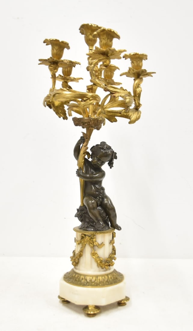 2-TONE FRENCH BRONZE & MARBLE CANDELABRA: 2-TONE FRENCH BRONZE & MARBLE CANDELABRA WITH PATINATED BRONZE PUTTI HOLDING 6-CANDLE GILT BRONZE FOLIATE CANDELABRA WITH BOWS & GARLANDS RAISED ON MARBLE BASE - 10" x 26"