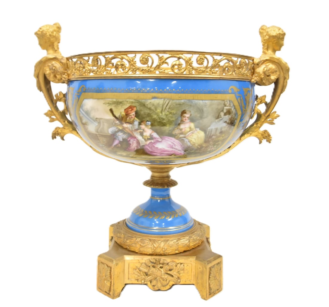 LARGE SEVRES PORCELAIN & BRONZE CENTERPIECE: LARGE SEVRES PORCELAIN & GILT BRONZE TWIN HANDLE CENTERPIECE BOWL WITH HAND PAINTED ROMANTIC SCENES MEDALLIONS IN LANDSCAPE HAVING BOUQUET OF FLOWERS INVERSO ; WITH FNE GILT BRONZE MOUNTS HAVING WINGE