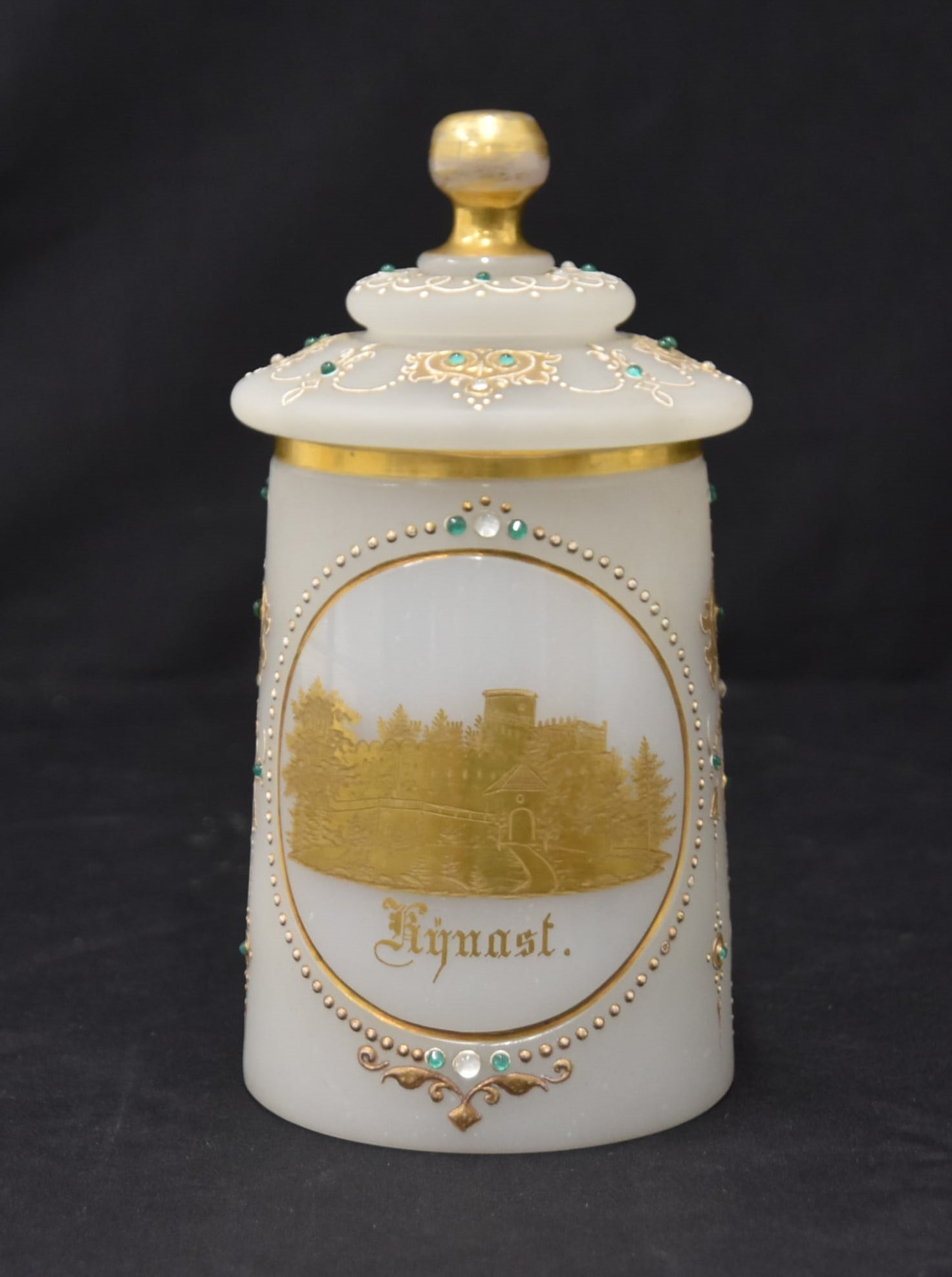 19th CENTURY JEWELED OPALINE LIDDED STEIN: 19th CENTURY OPALINE GLASS LIDDED STEIN WITH HEAVY GOLD MEDALLION VIEW OF KYNAST CASTLE IN POLAND ; SURROUNDED BY JEWELS & ENAMEL DECORATIONS - 4" x 6" x 7"