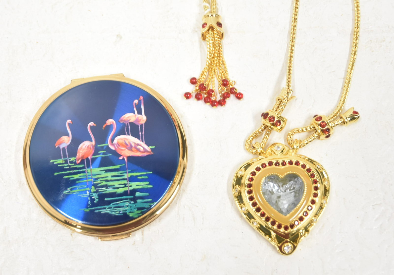 DESIGNER COSTUME JEWELRY LOT: ELIZABETH TAYLOR SLIDE NECKLACE WITH HEART - 20" / GERMAN SILVER CHAIN WITH ENAMEL & TURQUOISE PENDANT / NEVER USED STRATTON GOLD TONE & ENAMEL COMPACT ; MADE IN ENGLAND - 3"