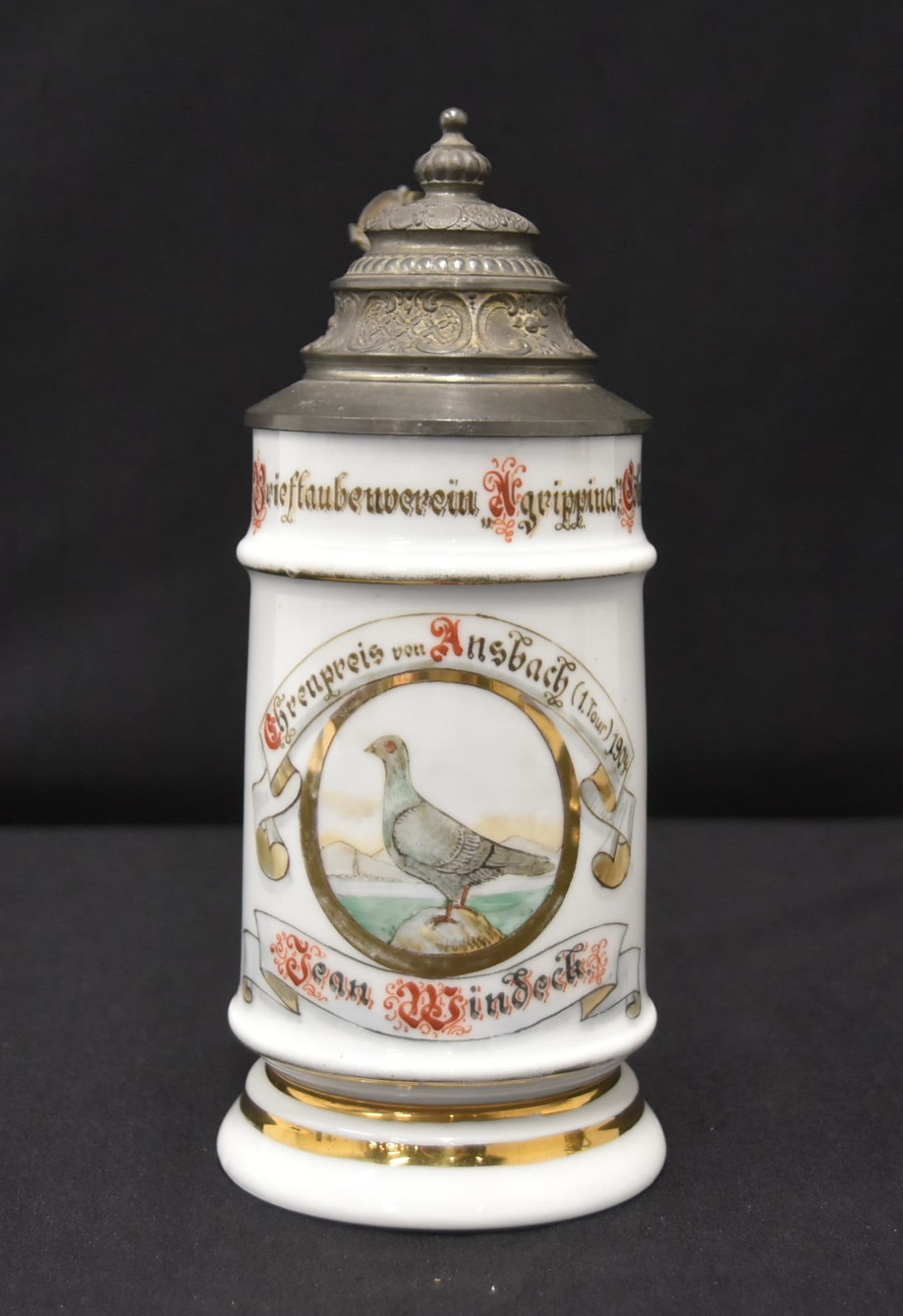 GERMAN PORCELAIN CARRIER PIGEON STEIN: GERMAN 1904 PORCELAIN STEIN WITH FIGURAL STREET SCENE MUSICIANS LITHOPHANE BOTTOM ; WITH HAND PAINTED CARRIER PIGEON BIRD ; CARRIER PIGEON ASSOCIATION FIRST PRZE 1904 ; JEAN WINDECK ; MARKED