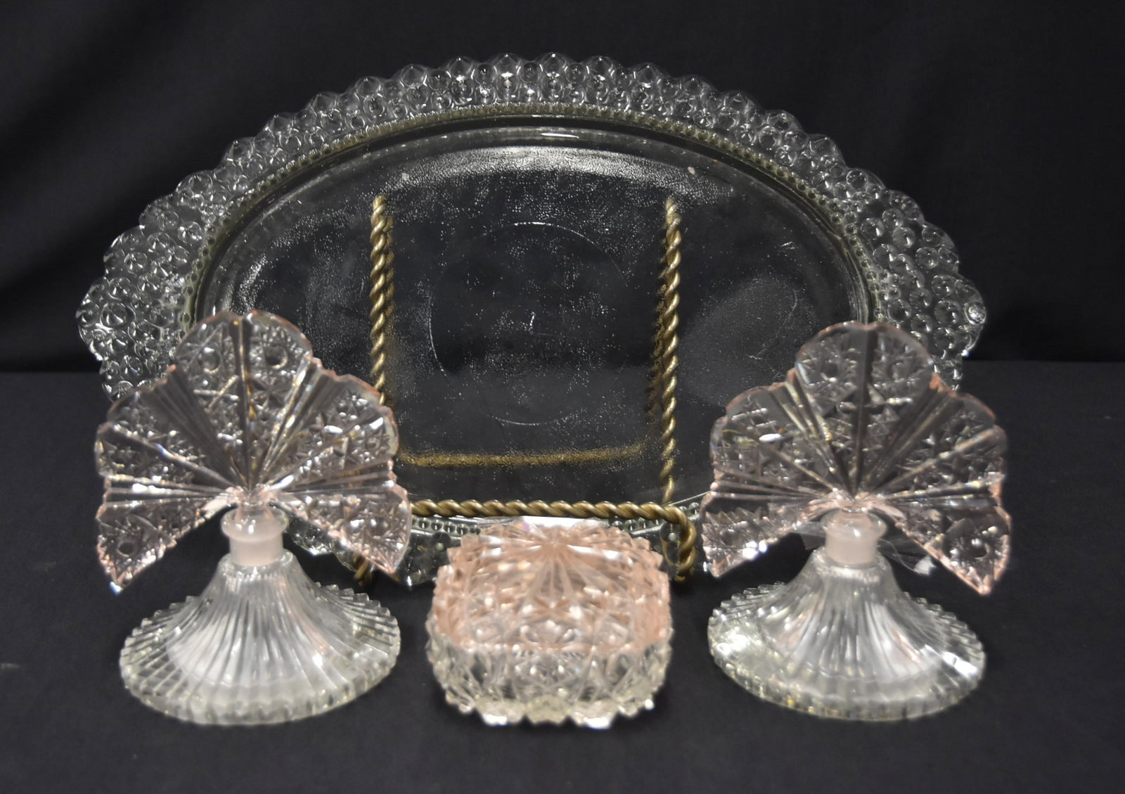 (Pr) PINK & CLEAR GLASS PERFUME BOTTLES & TRAY: (Pr) ANTIQUE PINK & CLEAR GLASS PERFUME BOTTLES WITH FAN SHAPED STOPPERS - 4" x 5 1/2' (ONE IS MISSING PIECE OF STOPPER) / PINK & CLEAR CUT GLASS BOX / DEPRESSION GLASS DRESSER TRAY - 15" x 9" (SOME