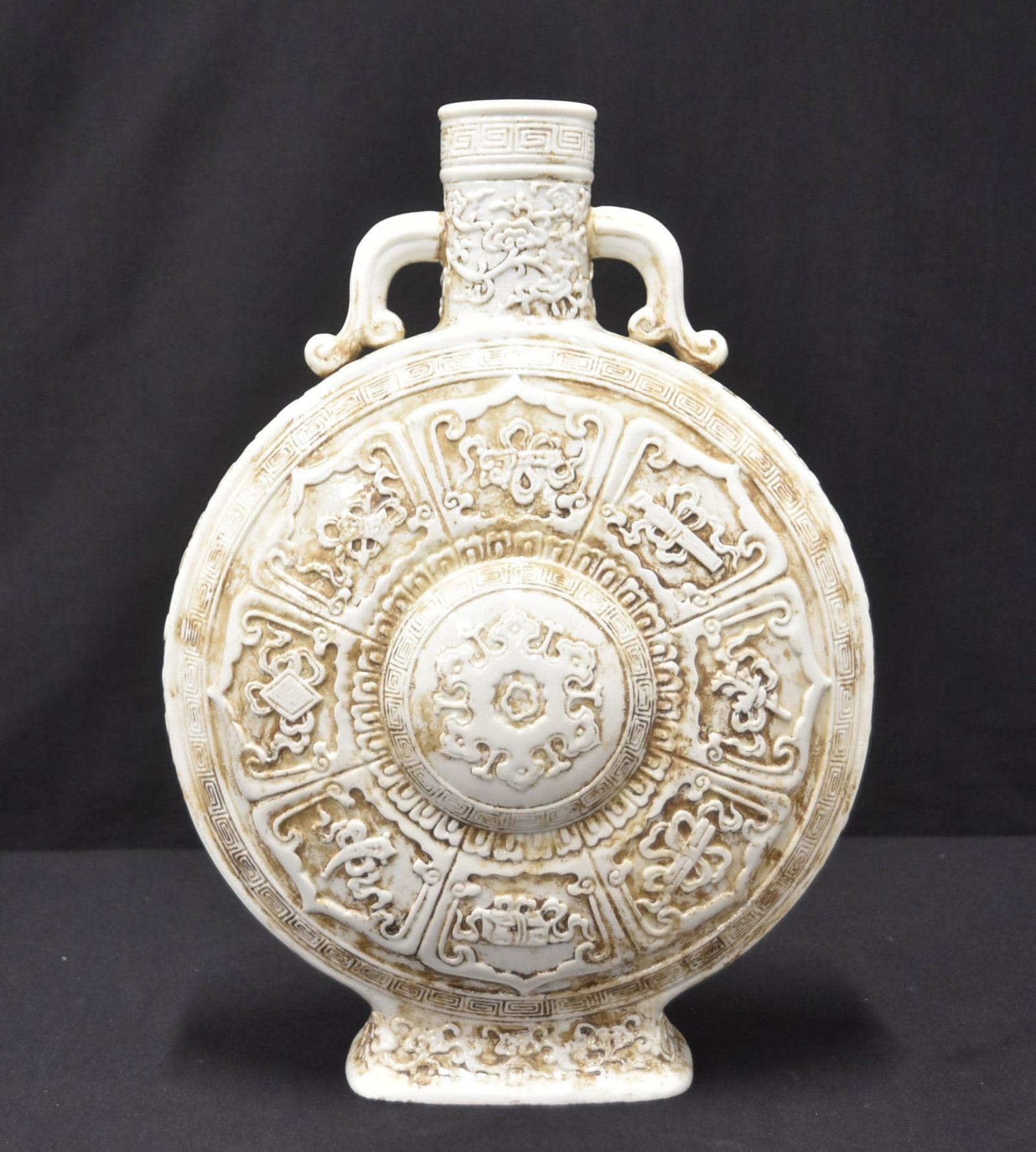 LARGE CHINESE PORCELAIN MOON FLASK: LARGE CHINESE PORCELAIN MOON FLASK WITH (8) RELIEF DECORATED SYMBOLS - 10" x 4" x 14"