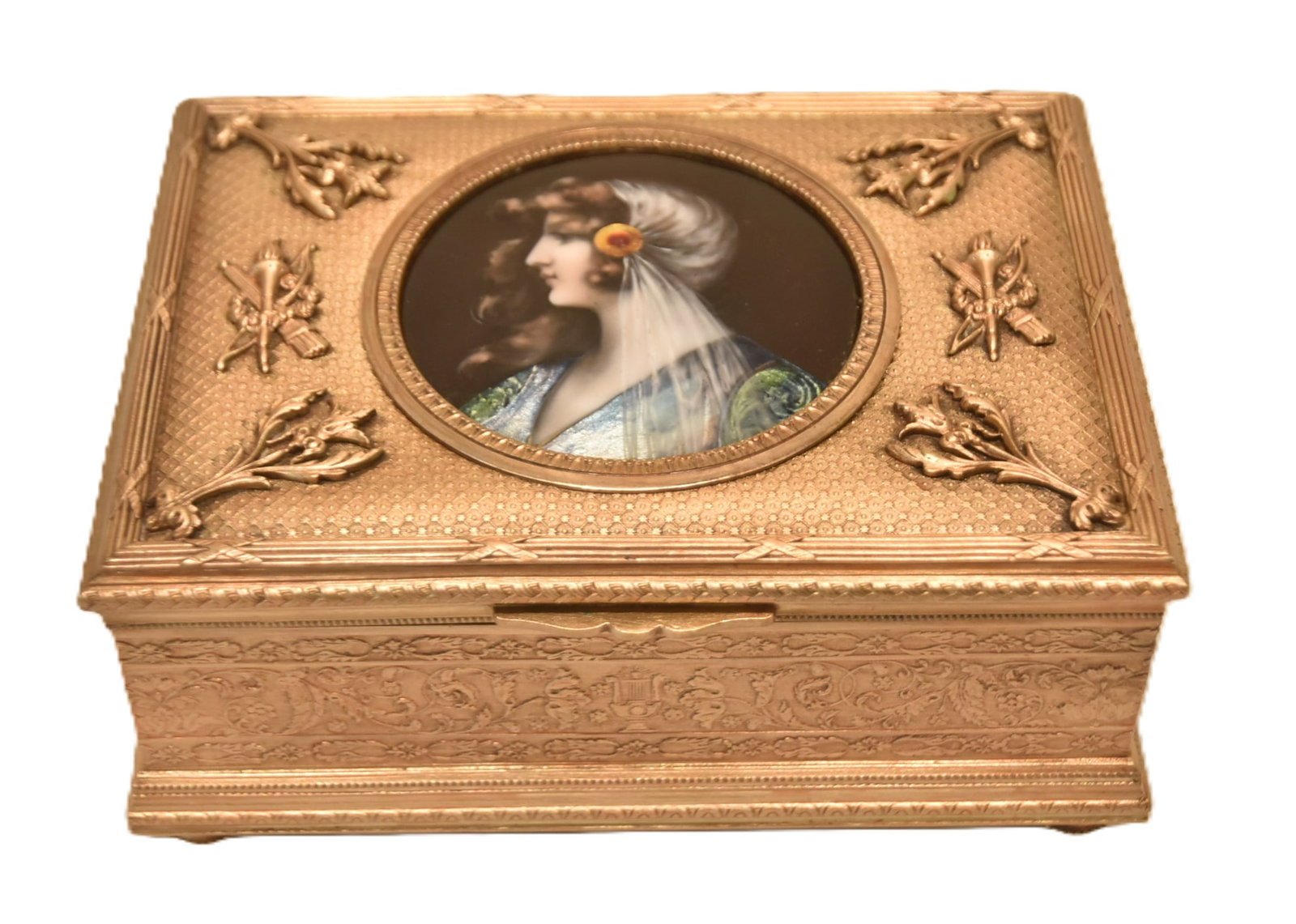 FRENCH BRONZE BOX WITH ENAMEL PORTRAIT: FRENCH BRONZE BOX WITH ART NOUVEAU LIMOGES ENAMEL PLAQUE OF WOMAN WITH FLOWEING HAIR ; ARTIST SIGNED ; BOX HAS TORCH & ARROW DESIGNS WITH RED INTERIOR LINER - 6" x 4" x 3" (PLEASE NOTE THIS ITEM IS BE