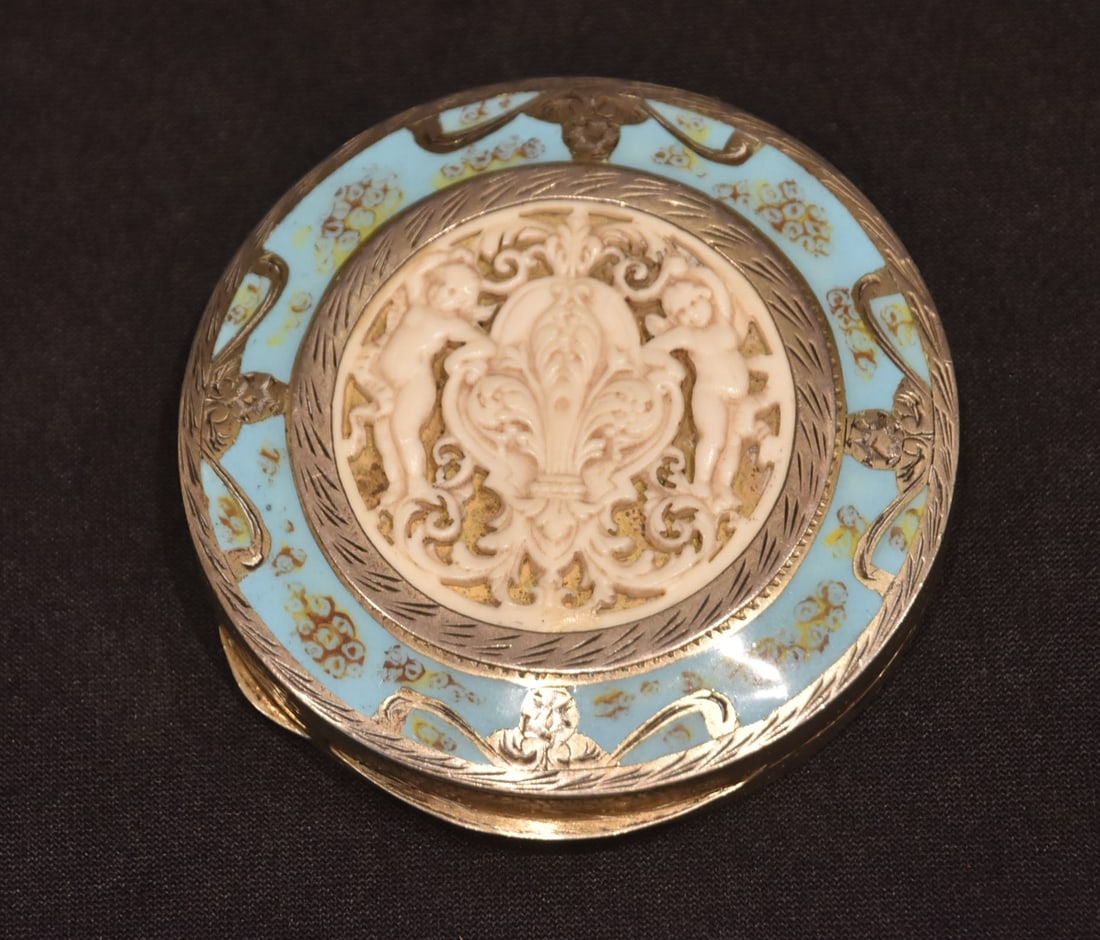 800 SILVER & ENAMEL COMPACT WITH CHERUB MEDALLION: 800 SILVER & BLUE ENAMEL COMPACT WITH CARVED BONE CHERUB & FLEUR DE LIS MEDALLION - 2 3/4" D ; 88grams GROSS (PLEASE NOTE THIS ITEM IS BEING SOLD AT AN OFF SITE LOCATION & PREVIEW IS UNAVAILABLE ; ITE