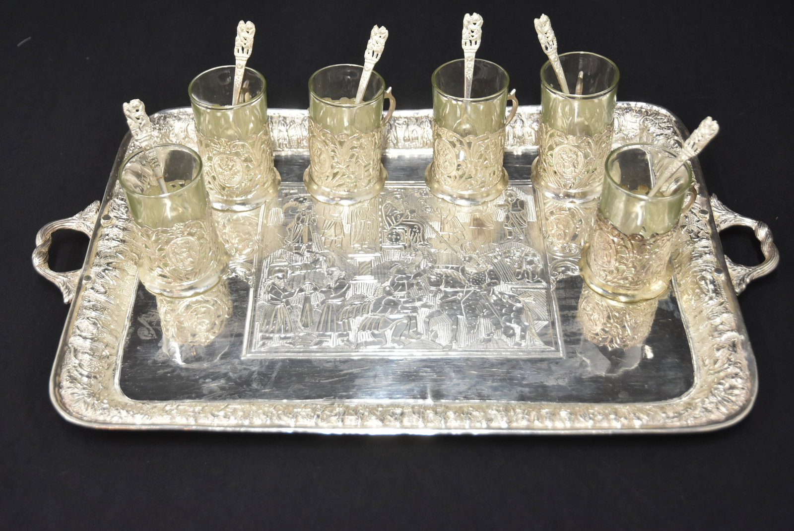 (13)pc PERSIAN SHIRAZ SILVER TEA SET: PERSIAN SHIRAZ SOLID SILVER REPOUSSE TWIN HANDLE SERVING TRAY WITH REPOUSSE FIGURAL SCENES AROUND BORDER & ENGRAVED CENTRAL MEDALLION - 19" x 11 1/2" ; WITH (6) RETICULATED SILVER CUPS WITH GLASS LINE
